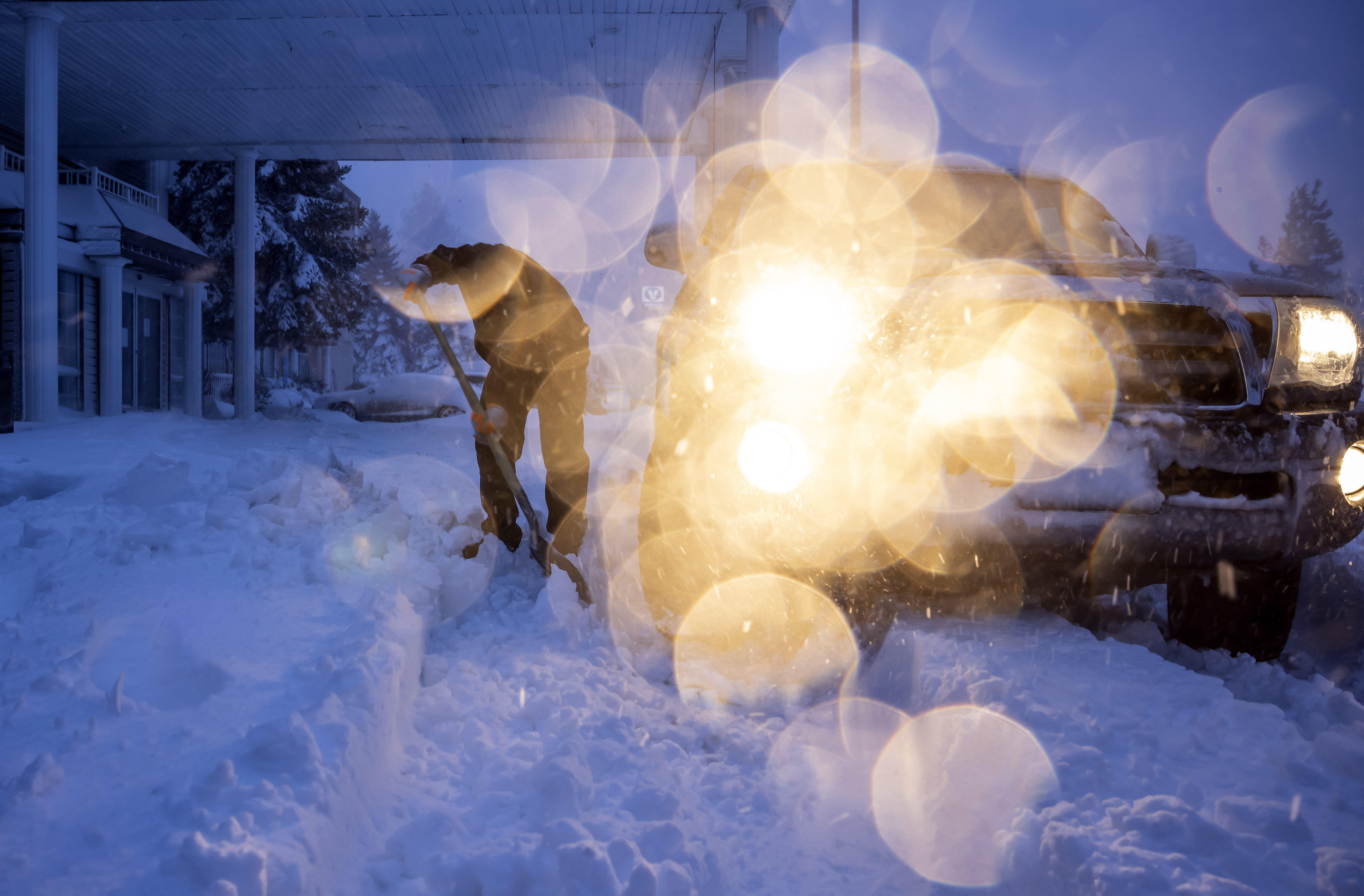 Daniel Sandoval tries to dig out his truck that got stuck in snow after dropping off his daughter at work in Weed, Calif., Wednesday, Nov. 20, 2024. (Carlos Avila Gonzalez/San Francisco Chronicle via AP)