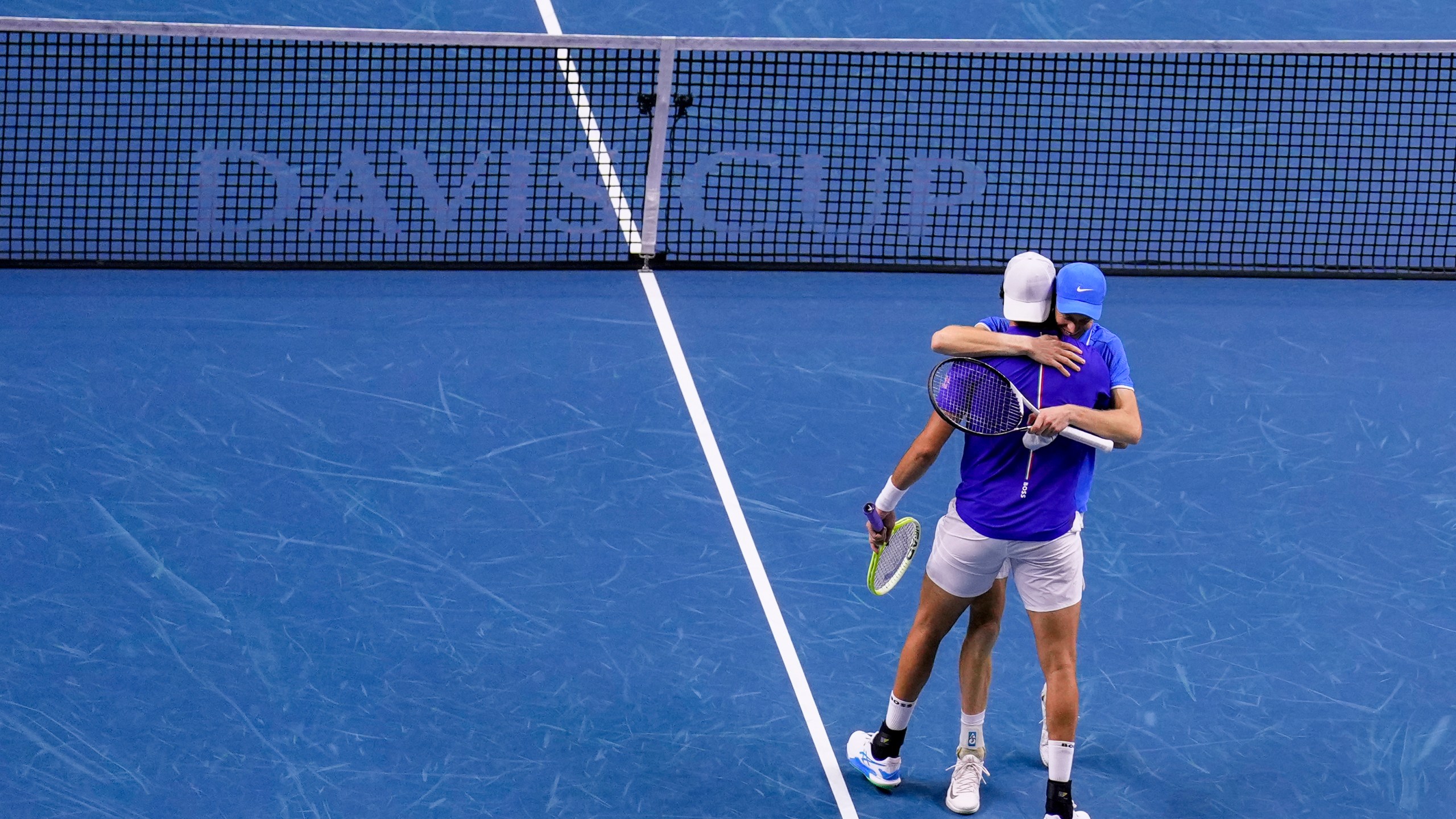 Italy's Jannik Sinner and Matteo Berrettini celebrate their victory against Argentina's Maximo Gonzalez and Andres Molteni during their doubles tennis quarterfinal Davis Cup match at the Martin Carpena Sports Hall in Malaga, southern Spain, on Thursday, Nov. 21, 2024. (AP Photo/Manu Fernandez)