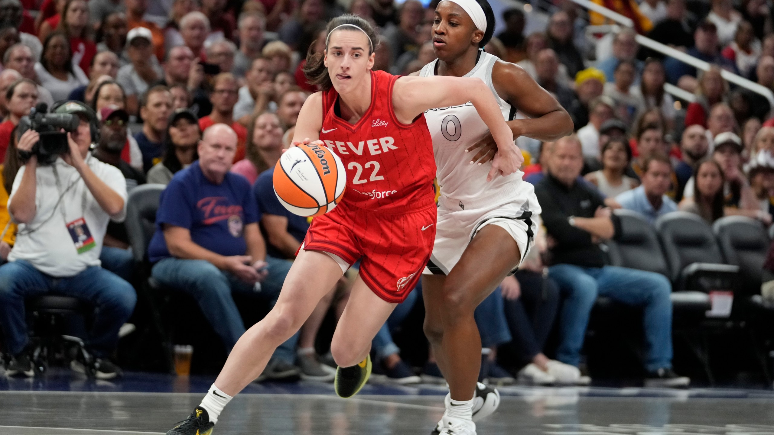 FILE - Indiana Fever's Caitlin Clark (22) goes to the basket against Las Vegas Aces' Jackie Young (0) during the first half of a WNBA basketball game, Sept. 11, 2024, in Indianapolis. (AP Photo/Darron Cummings, File)