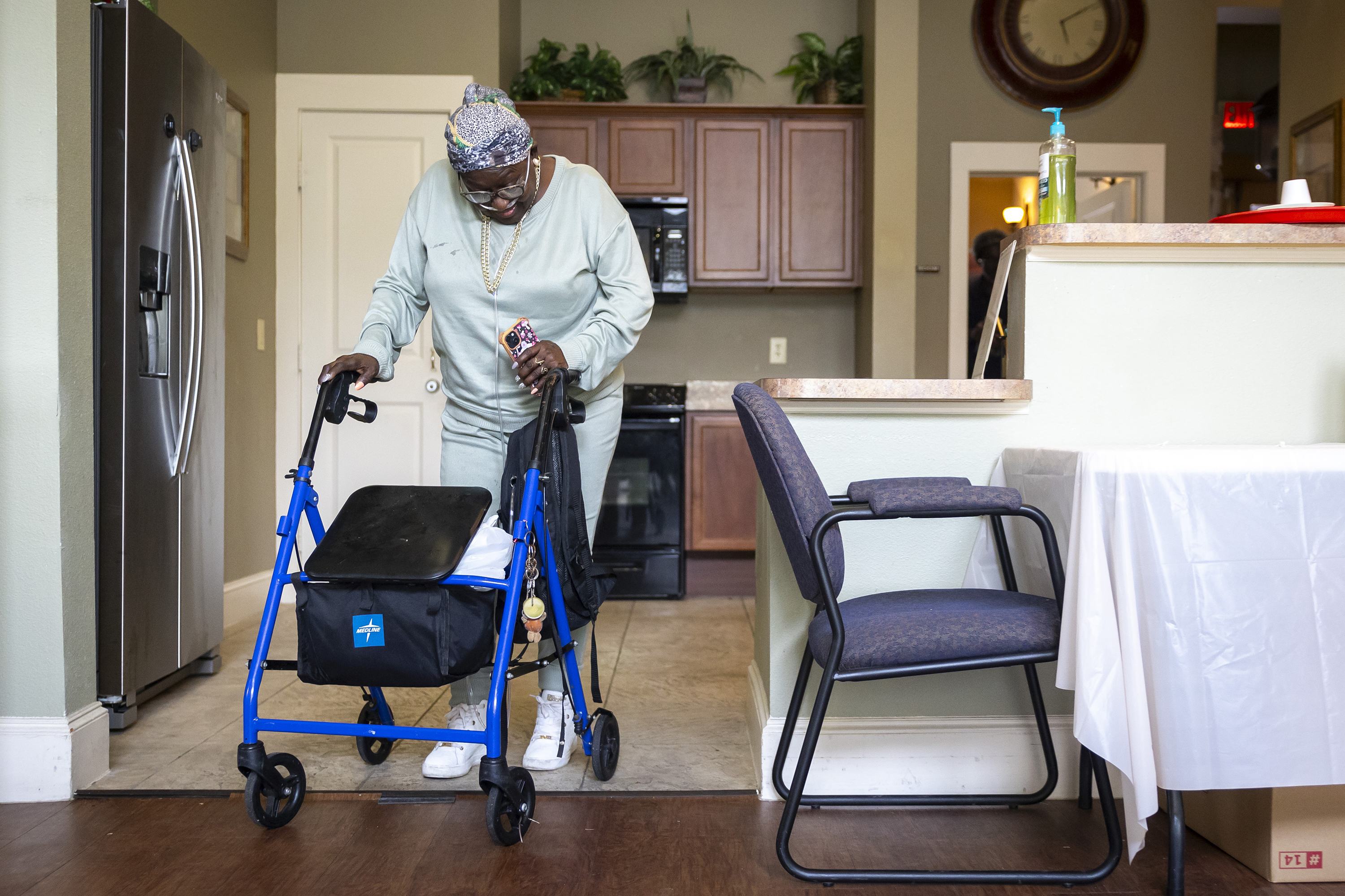 Patricia Johnican passes through a common kitchen area after Wednesday bingo at Commons of Grace Senior on Wednesday, Sept. 25, 2024, in Houston. (AP Photo / Annie Mulligan)