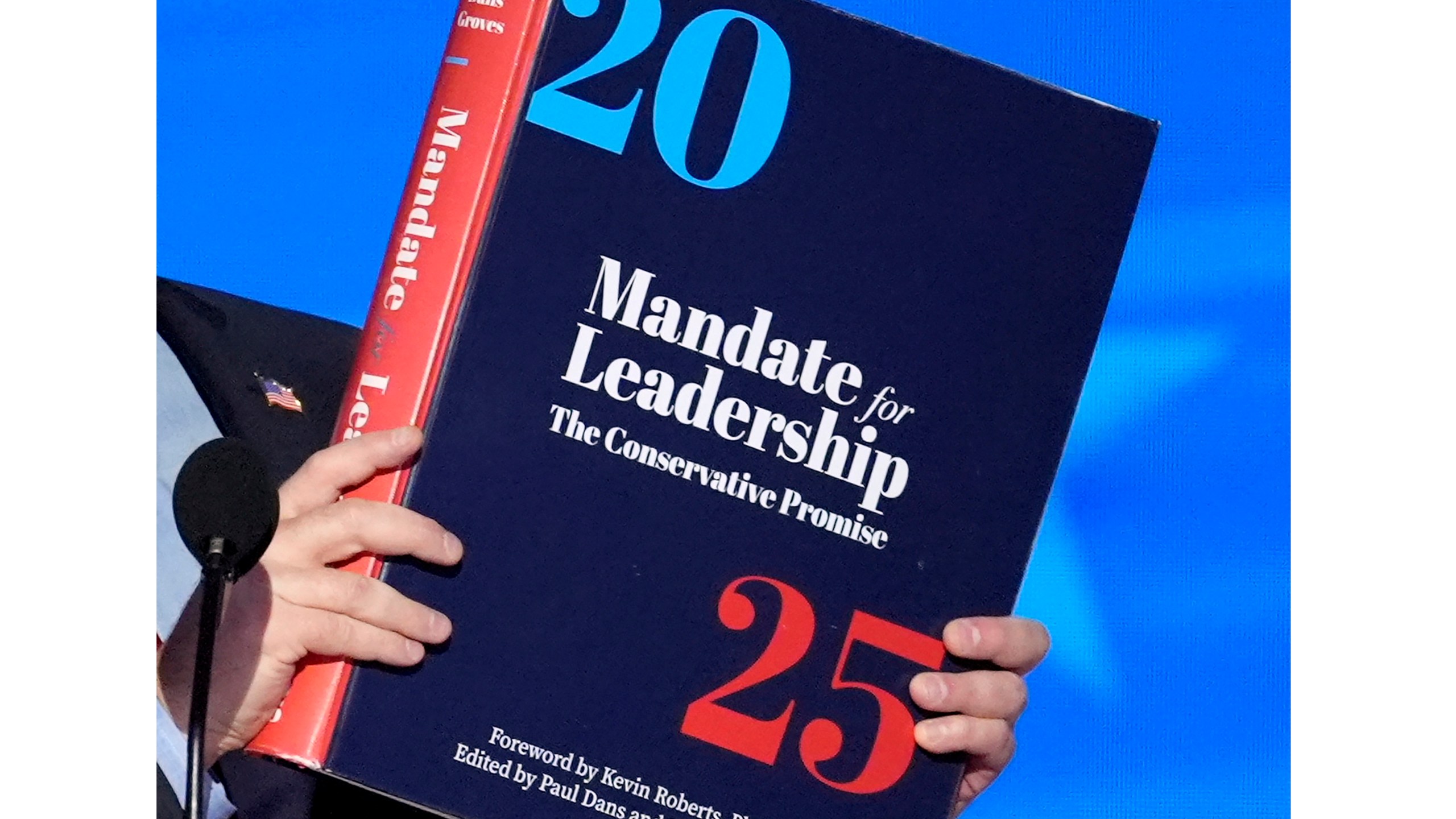 FILE - A copy of Project 2025 is held during the Democratic National Convention, Aug. 21, 2024, in Chicago. (AP Photo/J. Scott Applewhite, File)