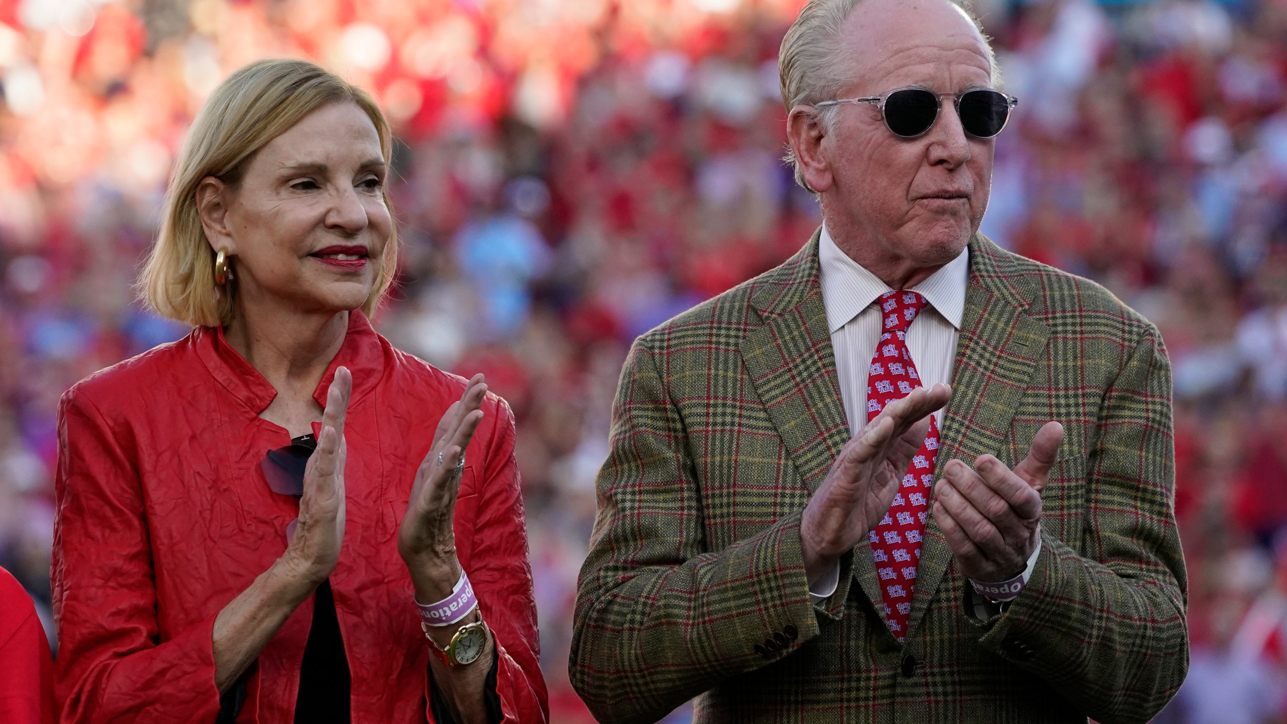 FILE - Former Mississippi and New Orleans Saints quarterback and father of former Mississippi and New York Giants quarterback Eli Manning, right and his wife Olivia Manning, applaud their son Eli, as he addresses the crowd during the retirement ceremony for his football jersey, number 10, during an NCAA college football game against LSU in Oxford, Miss., on Oct. 23, 2021. (AP Photo/Rogelio V. Solis, File)