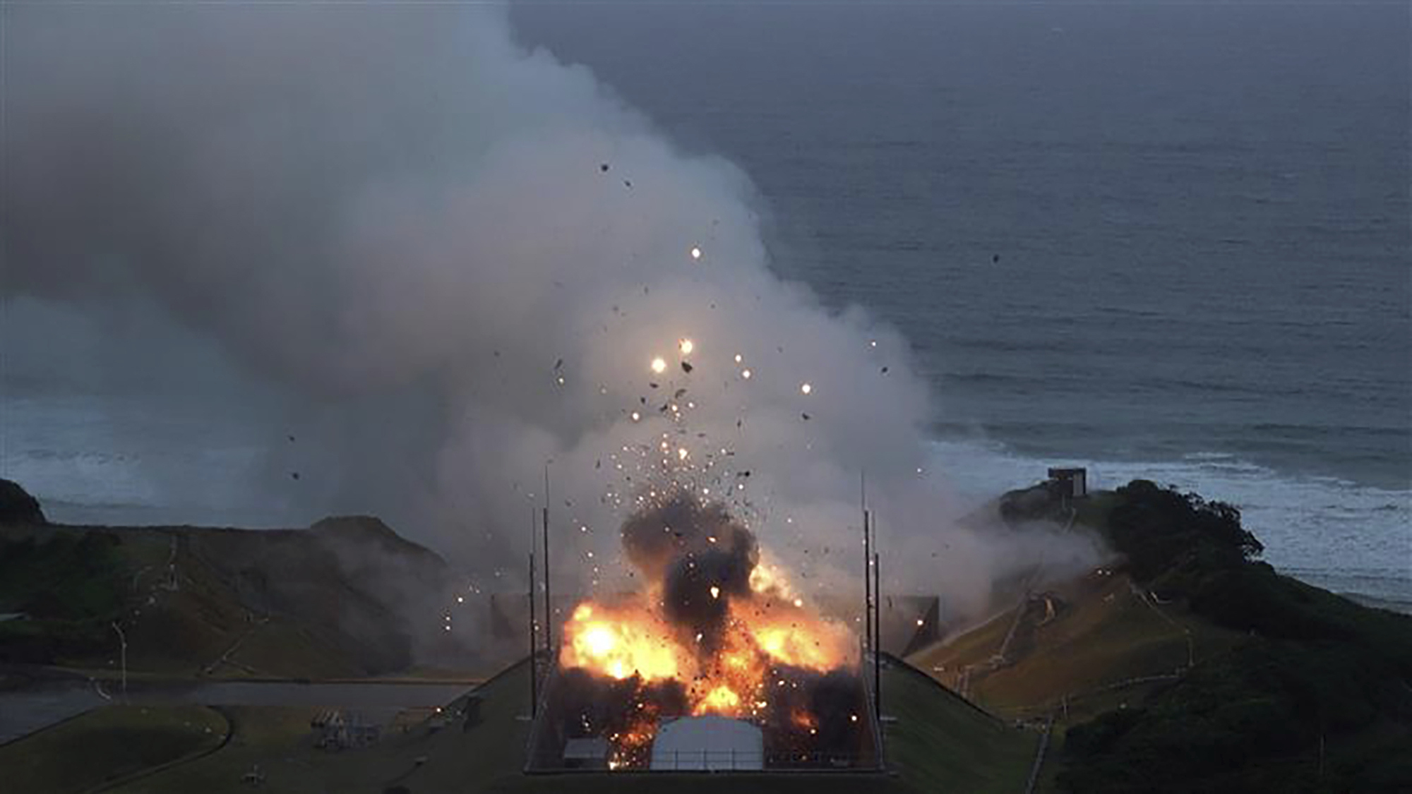 In this photo provided by Japan Aerospace Exploration Agency (JAXA), smoke and fire are seen during a combustion test of an engine for new small Japanese rocket Epsilon S at Tanegashima Space Center, Kagoshima prefecture, southern Japan, Tuesday, Nov. 26, 2024. (JAXA via AP)