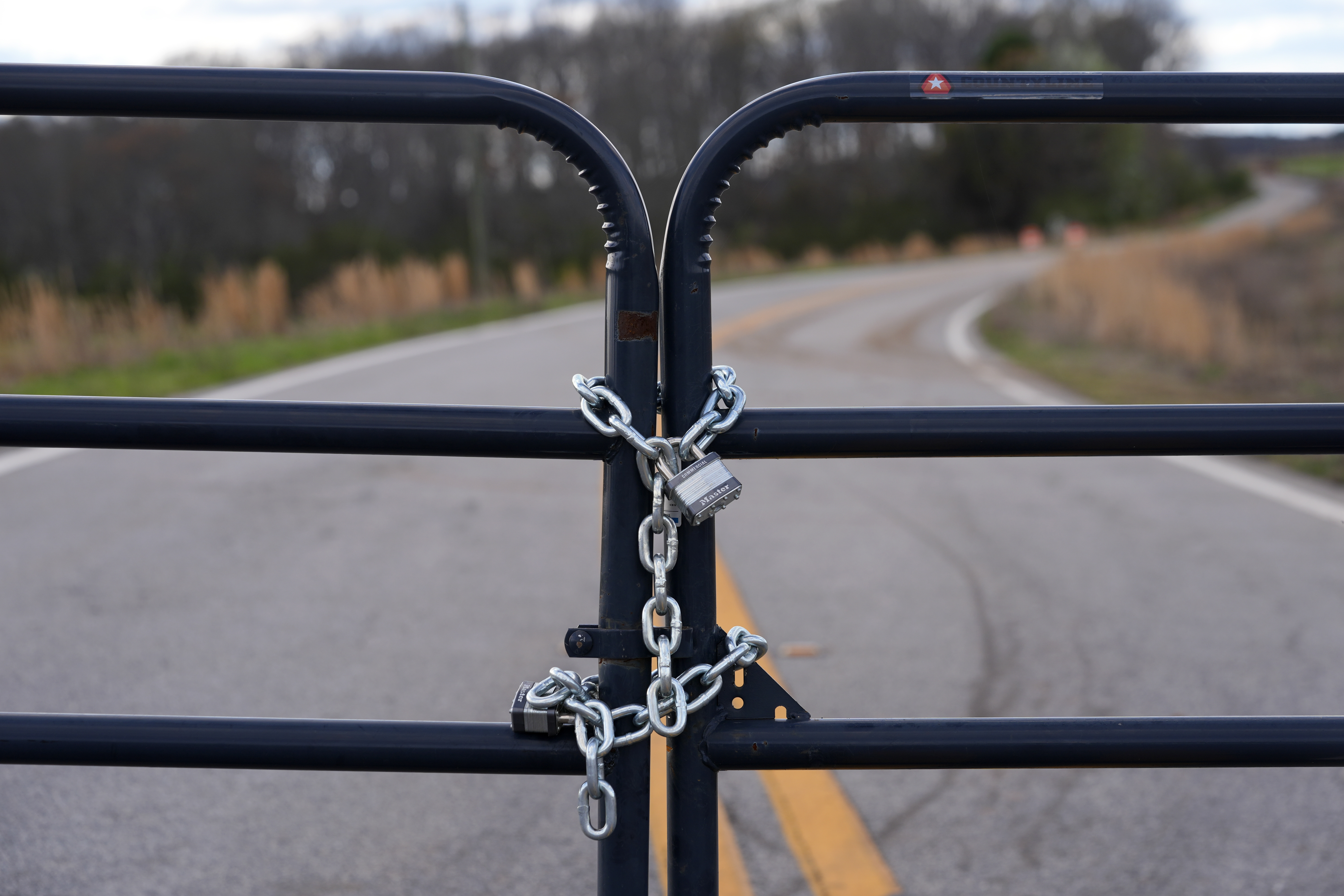 FILE - A locked gate on a closed road near the site of a planned Rivian electric truck plant is shown March 7, 2024, in Rutledge, Ga. (AP Photo/John Bazemore, File)