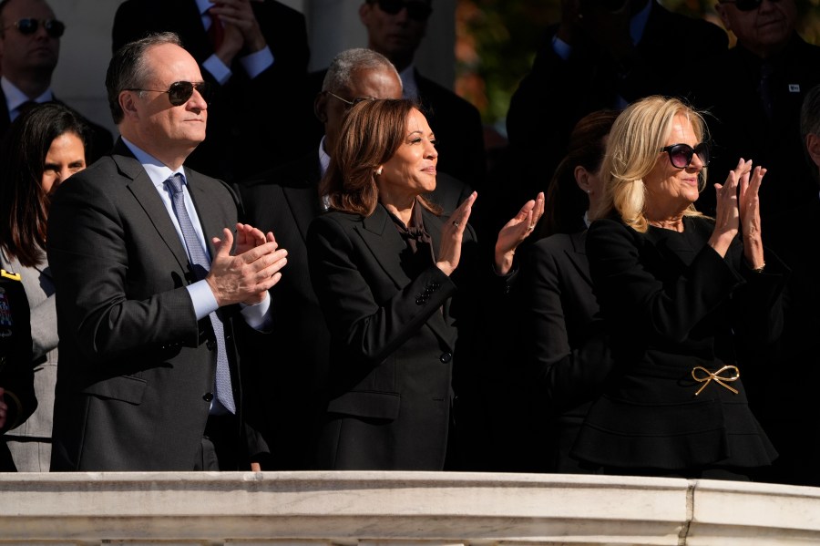 Second gentleman Doug Emhoff, from left, Vice President Kamala Harris and first lady Jill Biden attend the National Veterans Day Observance at the Memorial Amphitheater at Arlington National Cemetery in Arlington, Va., Monday, Nov. 11, 2024. (AP Photo/Mark Schiefelbein)