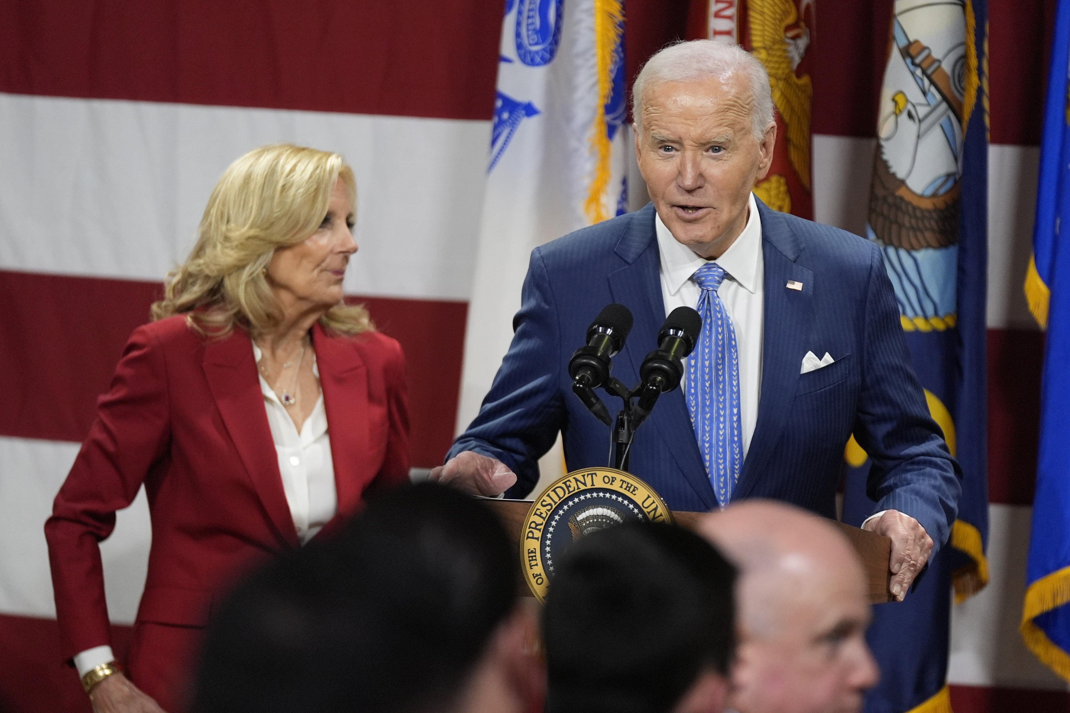 President Joe Biden speaks as first lady Jill Biden looks on at a Friendsgiving event with service members and their families in the Staten Island borough of New York, Monday, Nov. 25 2024. (AP Photo/Manuel Balce Ceneta)