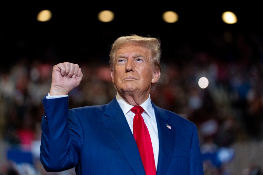 Republican presidential nominee former President Donald Trump pumps his fist as he arrives to speak at a campaign event at Nassau Coliseum, Wednesday, Sept.18, 2024, in Uniondale, N.Y. (AP Photo/Alex Brandon)