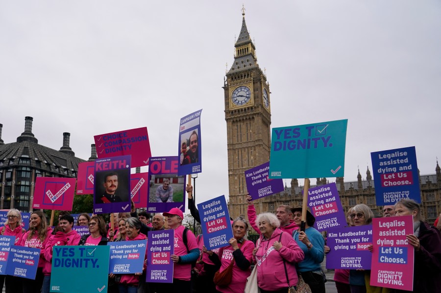 FILE - A small demonstration by people advocating assisted dying hold a protest outside the Hoses of Parliament as a bill to legalise assisted dying is to be put before lawmakers in London, England, Oct. 16, 2024. (AP Photo/Alberto Pezzali, File)