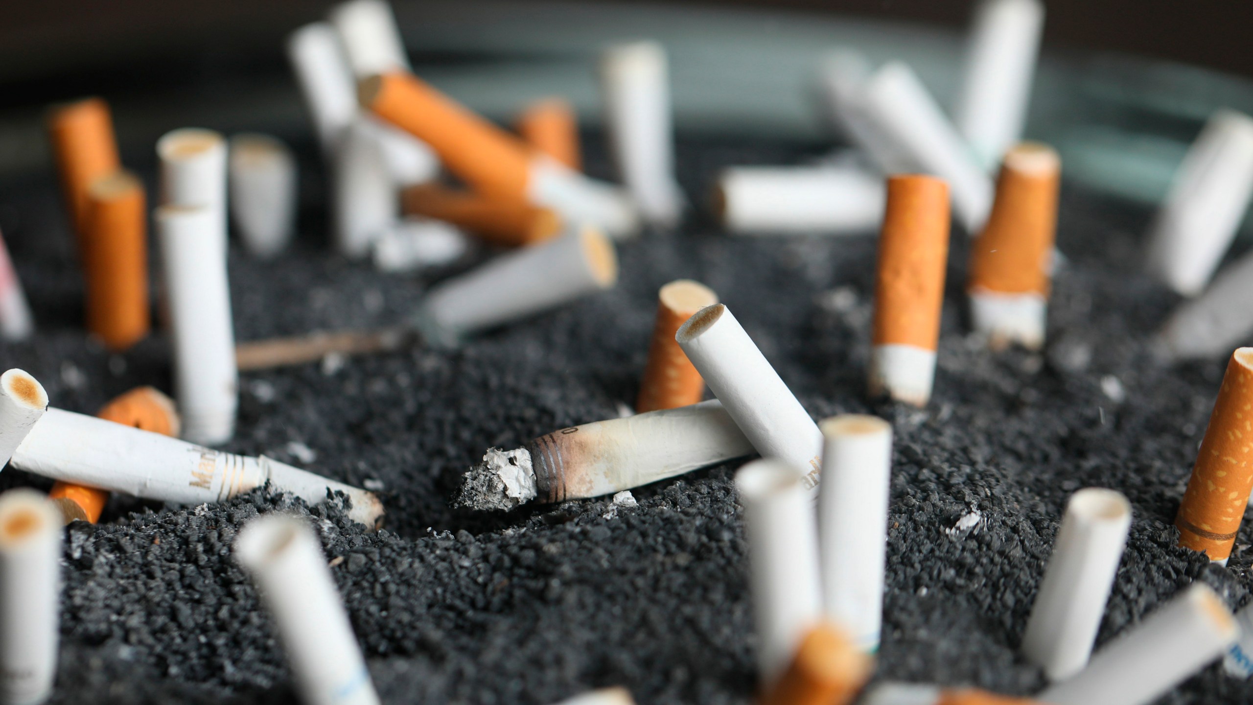 FILE - Cigarette butts sit in an ashtray on March 28, 2019, in New York. (AP Photo/Jenny Kane, File)