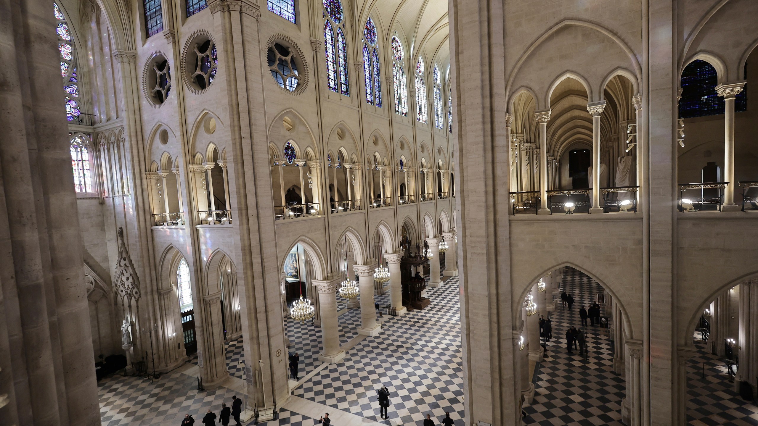 People stroll in Notre-Dame de Paris cathedral while French President Emmanuel Macron visits the restored interiors the monument, Friday, Nov.29, 2024 in Paris. (Christophe Petit Tesson, Pool via AP)