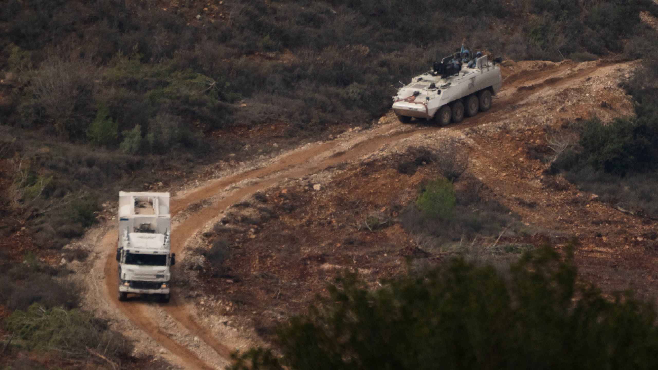 A convoy of the United Nations peacekeeping forces in Lebanon (UNIFIL) drives on area along the Israeli-Lebanese border as seen from northern Israel, Friday, Nov. 29, 2024. (AP Photo/Leo Correa)