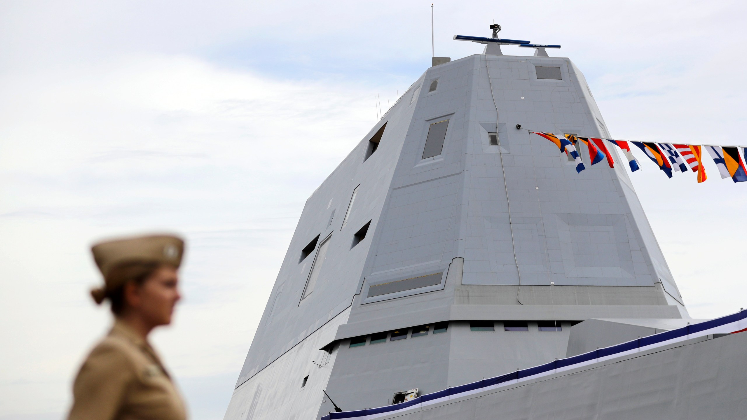 FILE - The deckhouse of the future USS Zumwalt, the U.S. Navy's newest guided-missile destroyer, stands past a member of the U.S. Navy in Baltimore, Oct. 13, 2016. (AP Photo/Patrick Semansky, File)