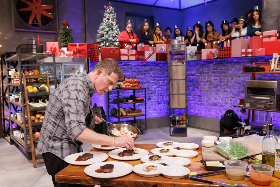 This image released by The Food Network shows Bobby Flay during an episode of the cooking series "Beat Bobby Flay: Holiday Throwdown." (Stephen Davis Phillips/Food Network via AP)