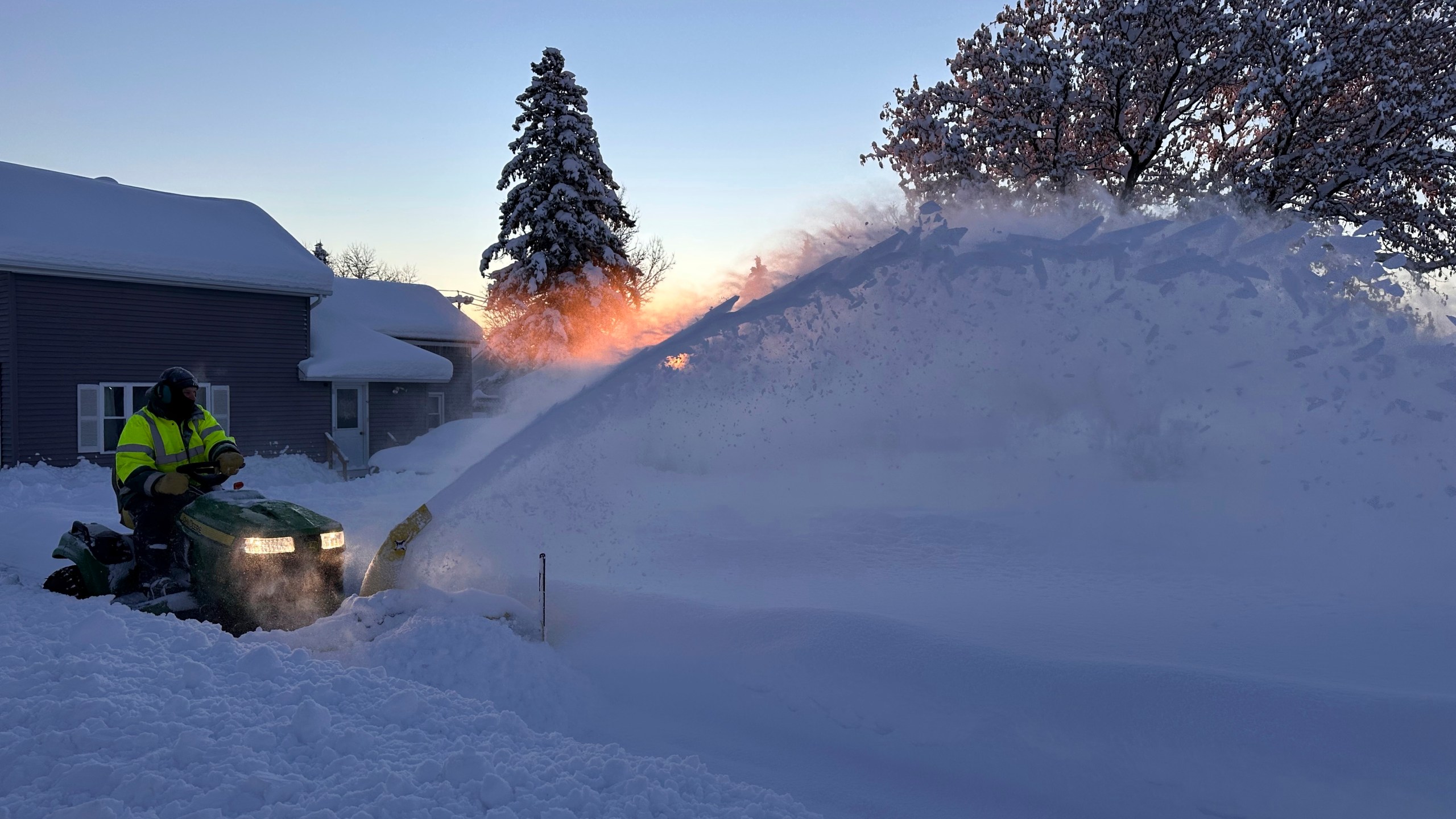 A snowplow clears snow as the sun rises in Lowville, N.Y., Monday, Dec. 2, 2024. (AP Photo/Cara Anna)