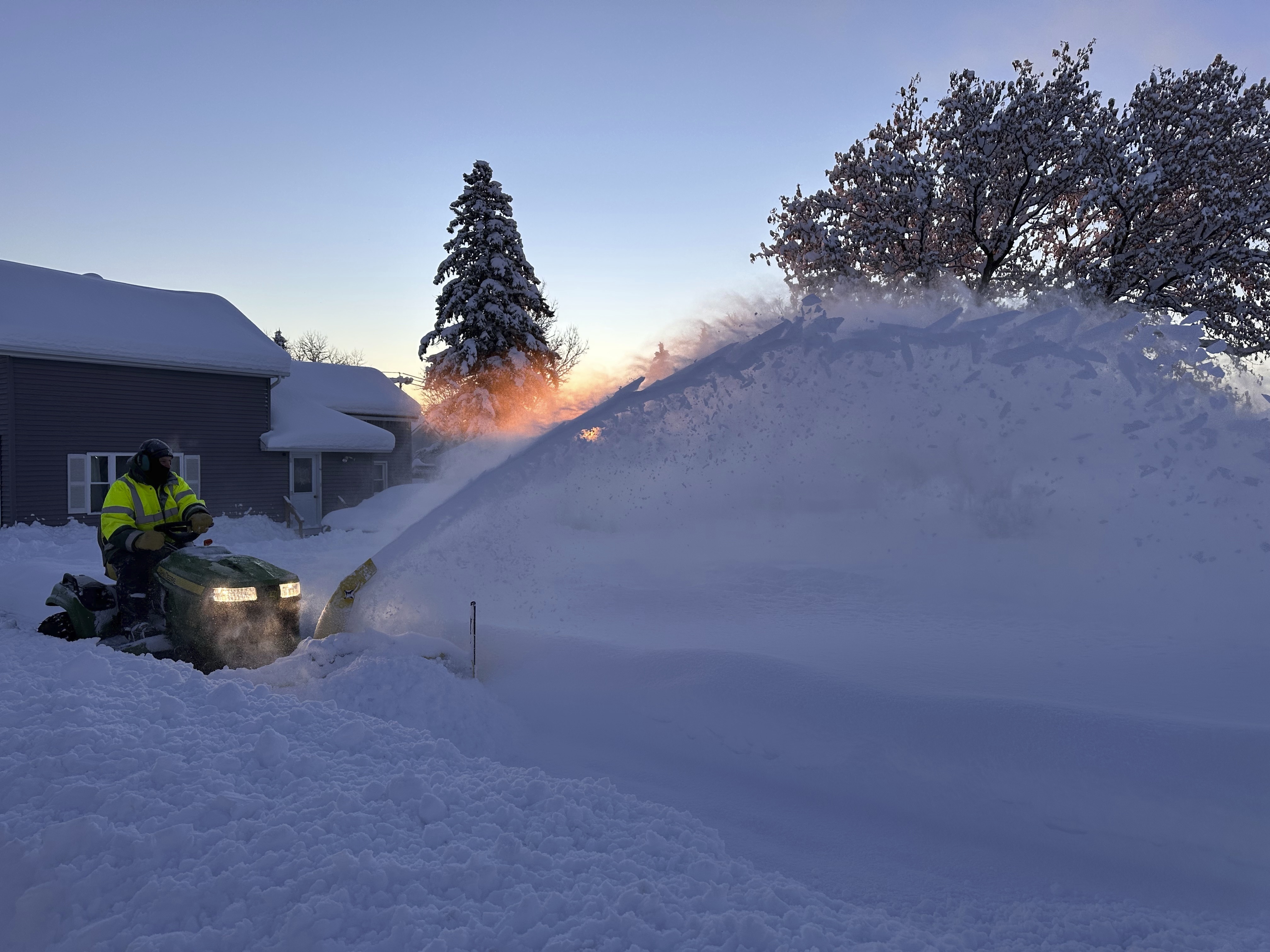 A snowplow clears snow as the sun rises in Lowville, N.Y., Monday, Dec. 2, 2024. (AP Photo/Cara Anna)