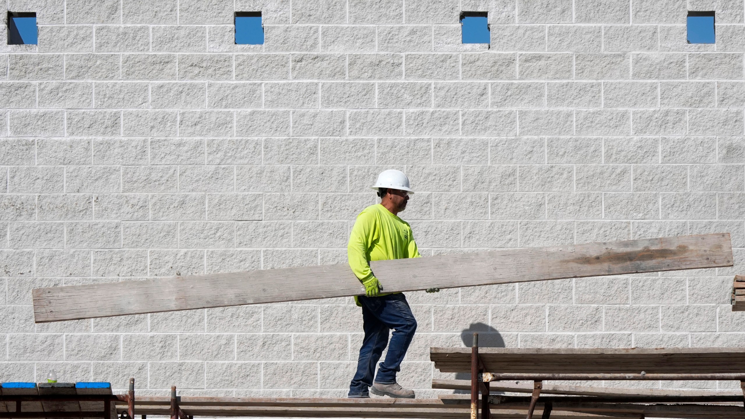 FILE - A construction worker walks on scaffolding at a building site on Sept. 4, 2024, in Waukee, Iowa. (AP Photo/Charlie Neibergall, File)