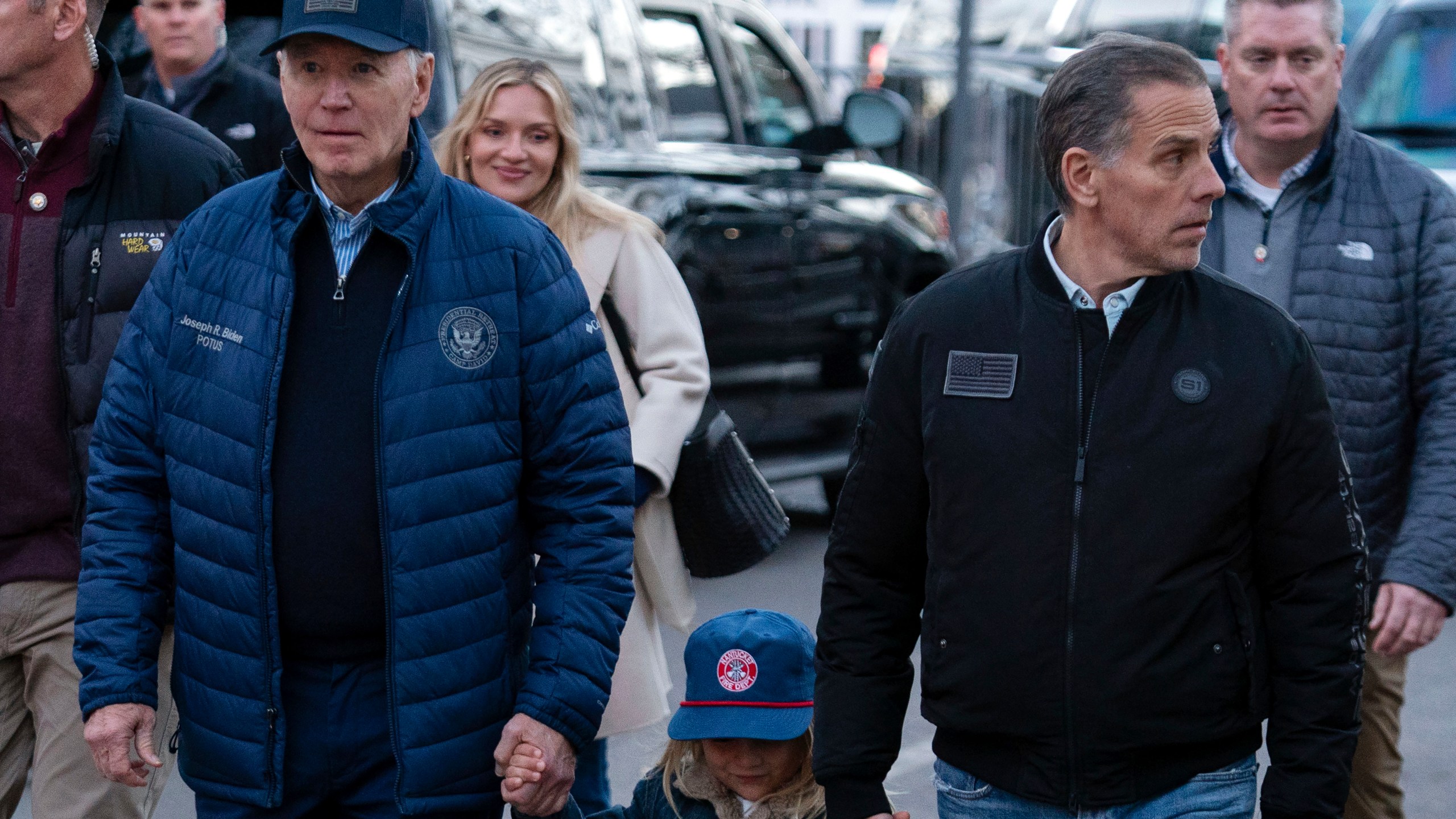 President Joe Biden with his son Hunter Biden and his grandson Beau walk in downtown Nantucket Mass., Friday, Nov. 29, 2024. (AP Photo/Jose Luis Magana)