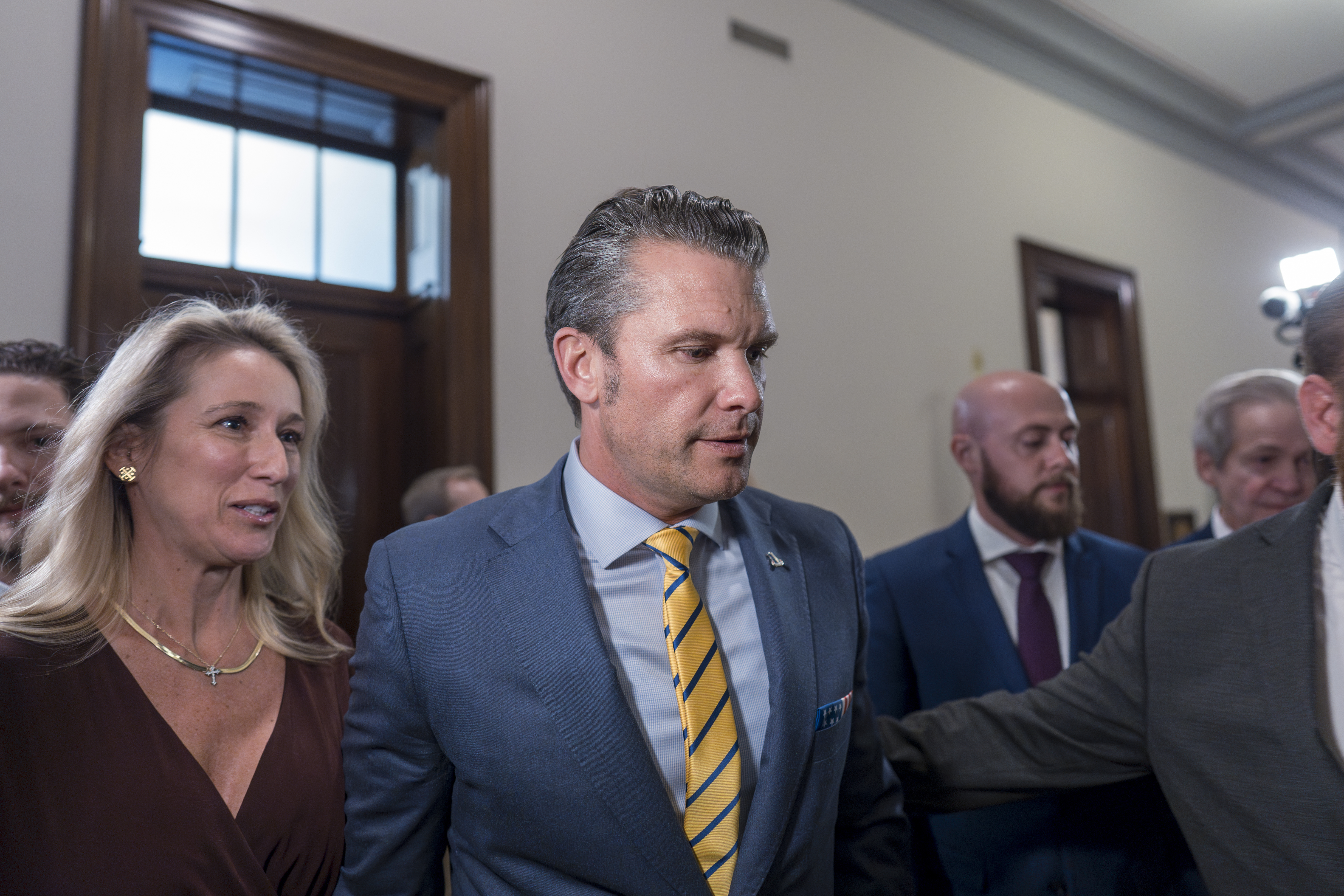 Pete Hegseth, President-elect Donald Trump's nominee to be defense secretary, is joined by his wife Jennifer Rauchet, left, as they arrive to meet with Sen. Ted Budd, R-N.C., a member of the Senate Armed Services Committee, at the Capitol in Washington, Tuesday, Dec. 3, 2024. (AP Photo/J. Scott Applewhite)