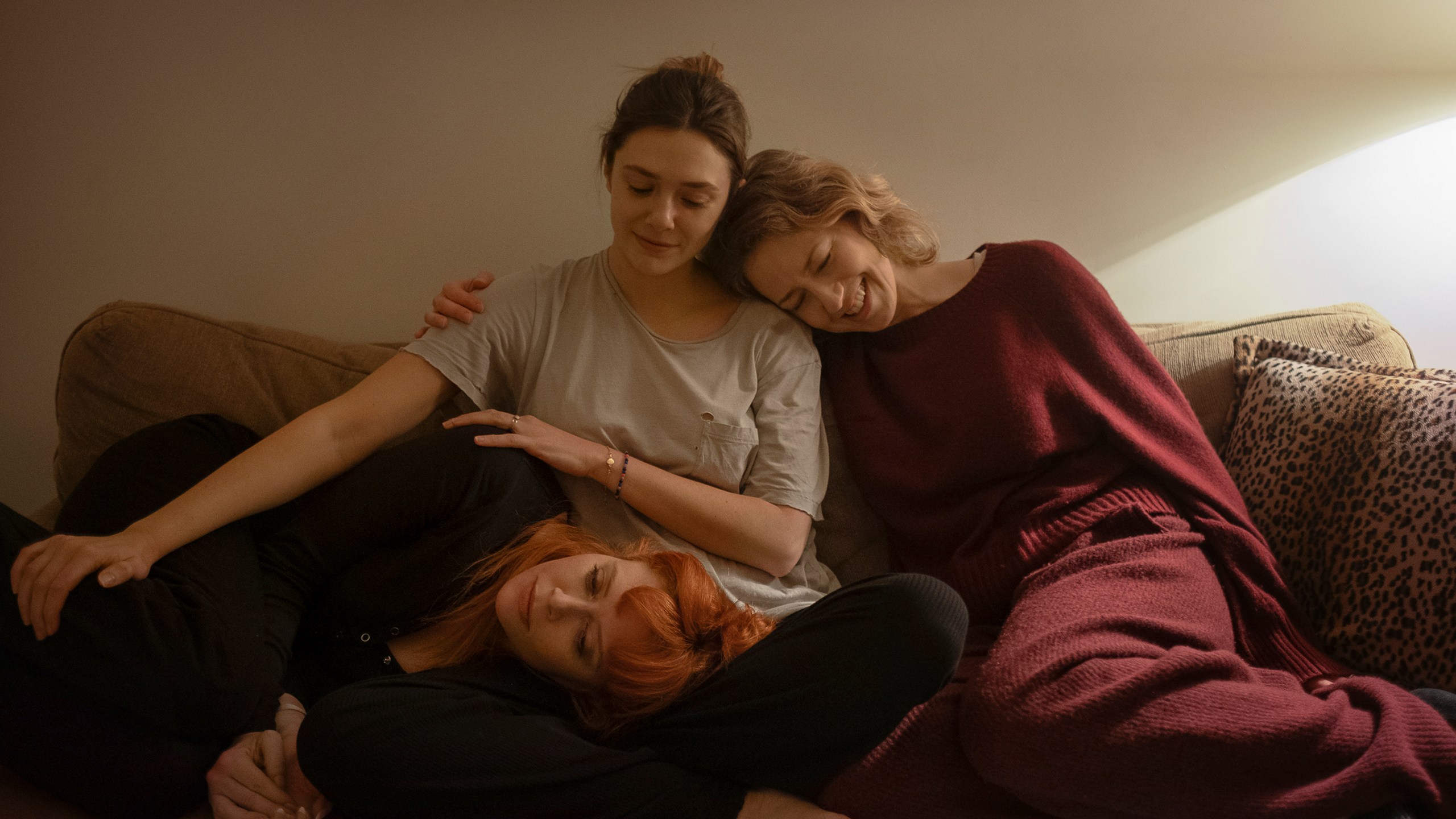 This image released by Netflix shows Natasha Lyonne, from left, Elizabeth Olsen, and Carrie Coon in a scene from "His Three Daughters." (Netflix via AP)