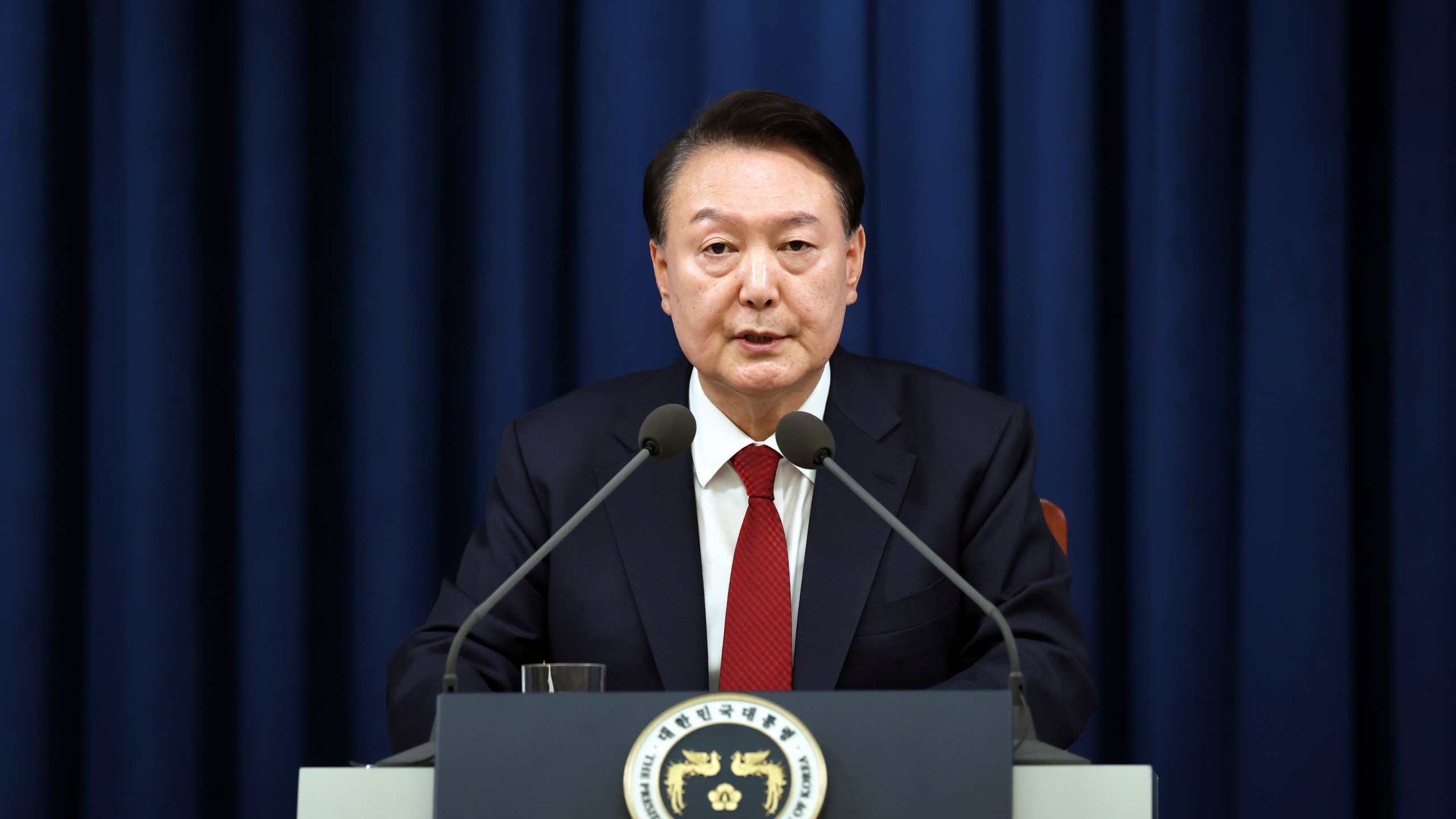 In this photo provided by South Korea Presidential Office, South Korean President Yoon Suk Yeol speaks during a press briefing at the presidential office in Seoul, South Korea, Tuesday, Dec. 3, 2024. (South Korea Unification Ministry via AP).