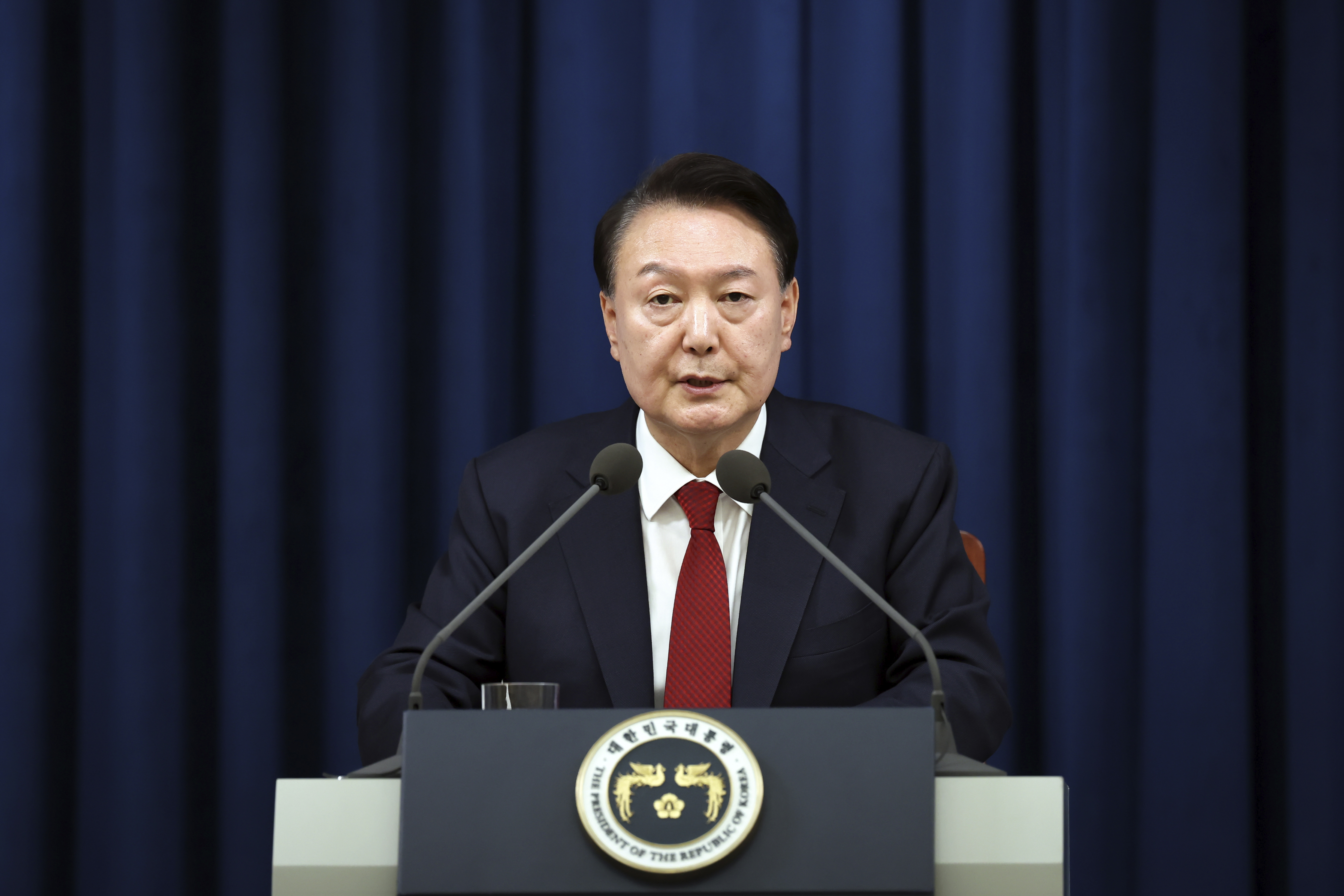 In this photo provided by South Korea Presidential Office, South Korean President Yoon Suk Yeol speaks during a press briefing at the presidential office in Seoul, South Korea, Tuesday, Dec. 3, 2024. (South Korea Unification Ministry via AP).