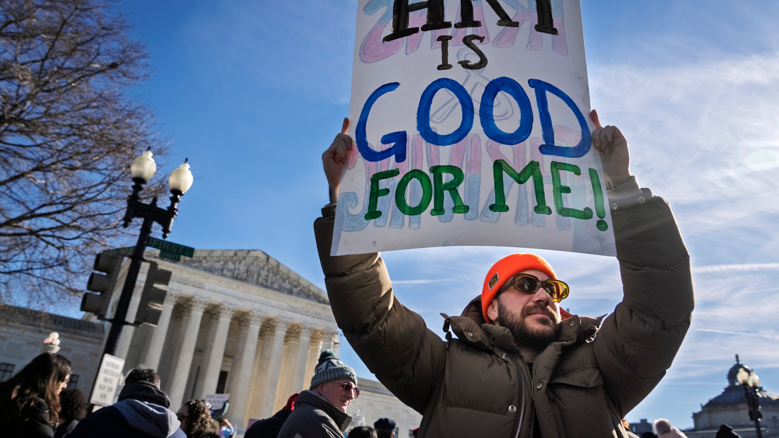 Kyle Lansky, of the organization Transanta, rallies with other supporters of transgender rights by the Supreme Court, Wednesday, Dec. 4, 2024, while arguments are underway in a case regarding a Tennessee law banning gender-affirming medical care for transgender youth. (AP Photo/Jacquelyn Martin)