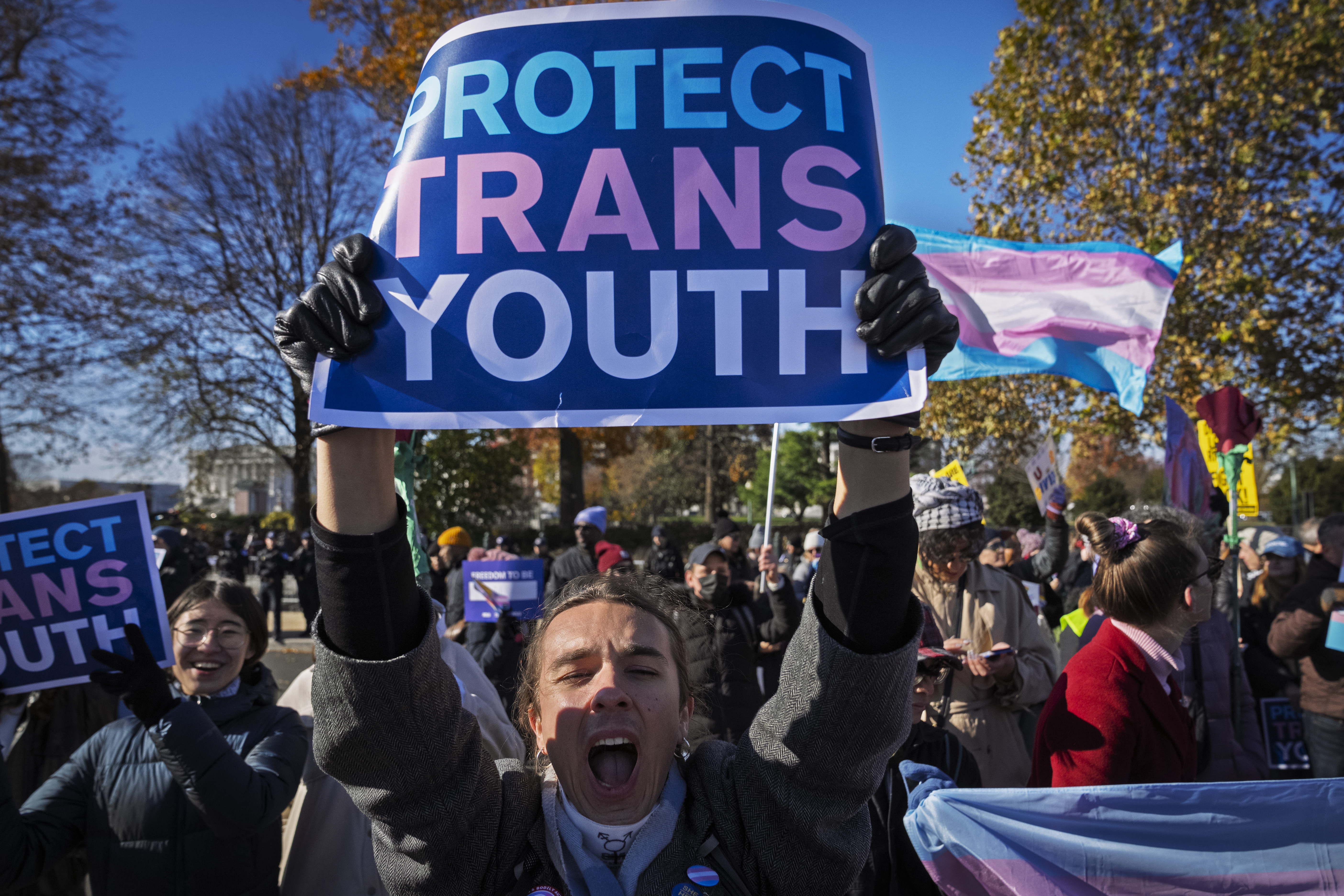 A young person who preferred not to give her name, cheers as supporters of transgender rights rally by the Supreme Court, Wednesday, Dec. 4, 2024, in Washington, while arguments are underway in a case regarding a Tennessee law banning gender-affirming medical care for transgender youth. (AP Photo/Jacquelyn Martin)