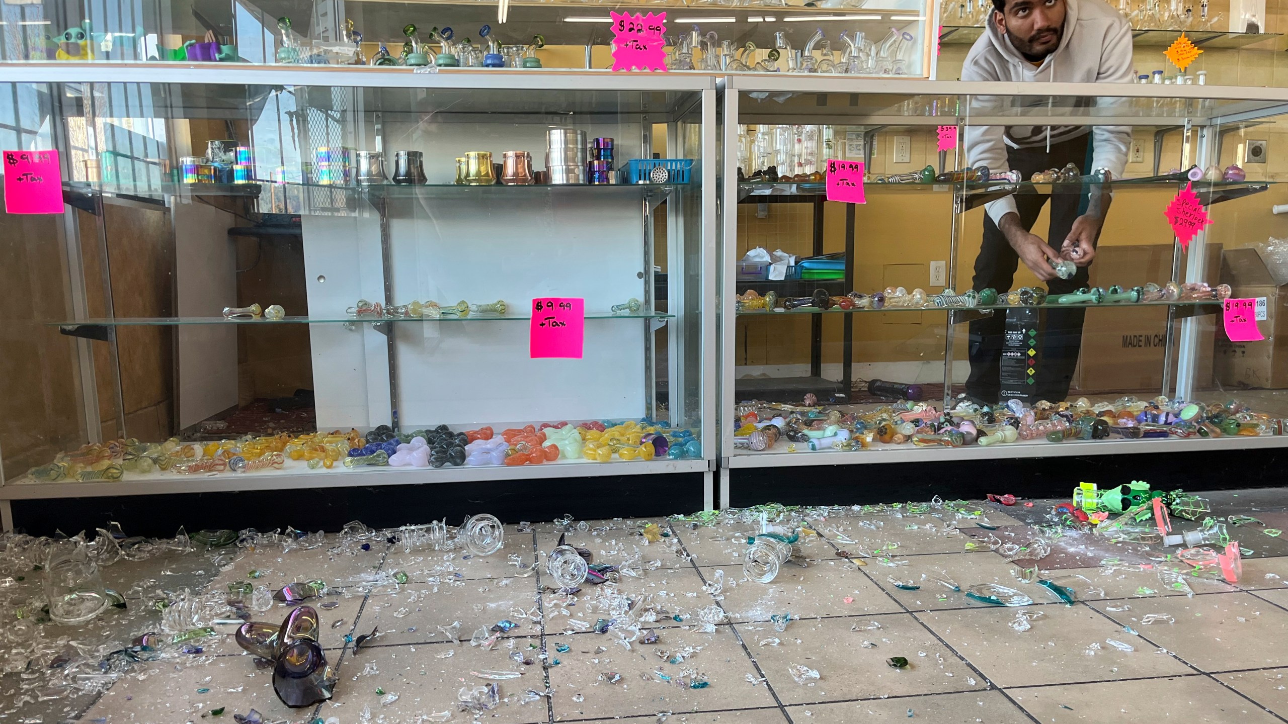 Hasan Raza cleans up in the aftermath of a 7.0 earthquake inside E&J Liquors, Thursday, Dec. 5, 2024, in Rio Dell, Calif. (Savana Robinson via AP)