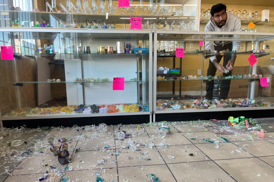 Hasan Raza cleans up in the aftermath of a 7.0 earthquake inside E&J Liquors, Thursday, Dec. 5, 2024, in Rio Dell, Calif. (Savana Robinson via AP)