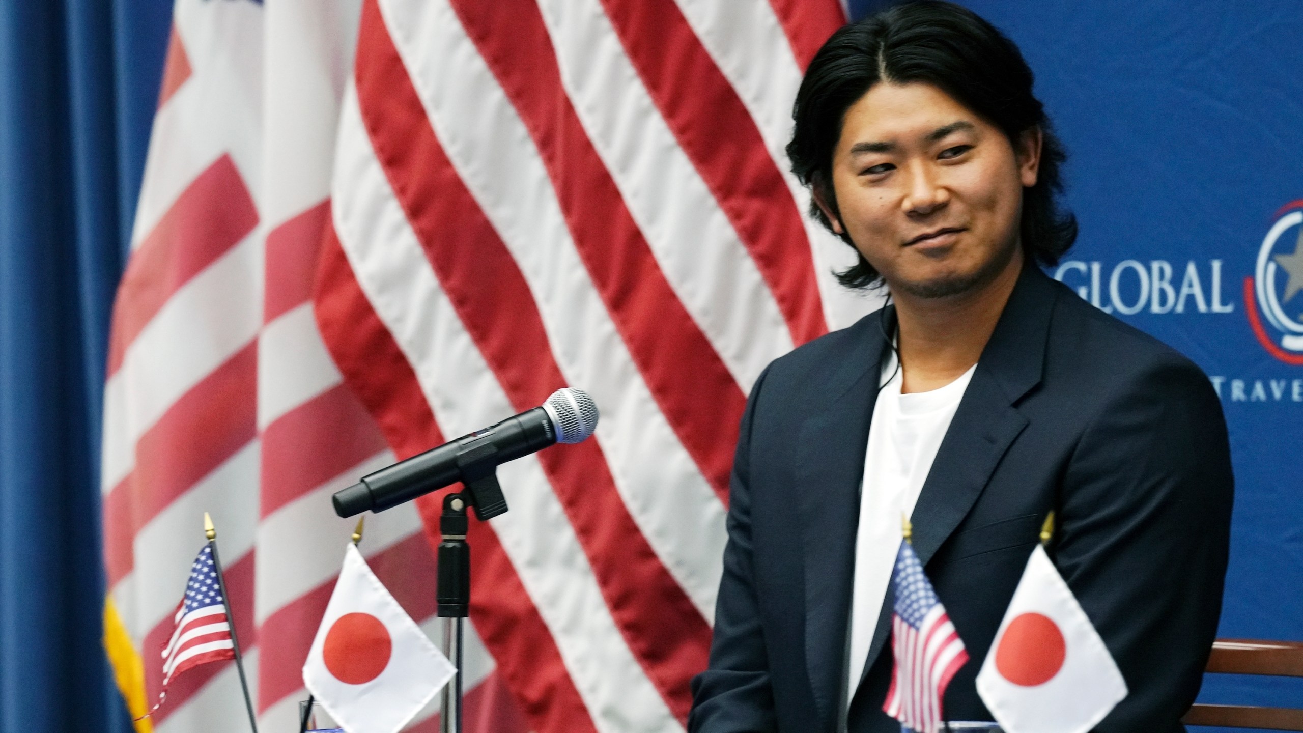 Shota Imanaga, a Japanese pitcher of the Chicago Cubs, smiles during a news conference at the U.S. Embassy Monday, Dec. 9, 2024, in Tokyo, as he was invited to the event dubbed the U.S. Global Entry to promote a way for travelers to get quicker clearance on arrival. (AP Photo/Eugene Hoshiko)