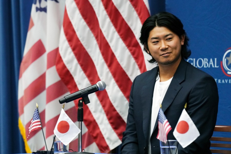 Shota Imanaga, a Japanese pitcher of the Chicago Cubs, smiles during a news conference at the U.S. Embassy Monday, Dec. 9, 2024, in Tokyo, as he was invited to the event dubbed the U.S. Global Entry to promote a way for travelers to get quicker clearance on arrival. (AP Photo/Eugene Hoshiko)