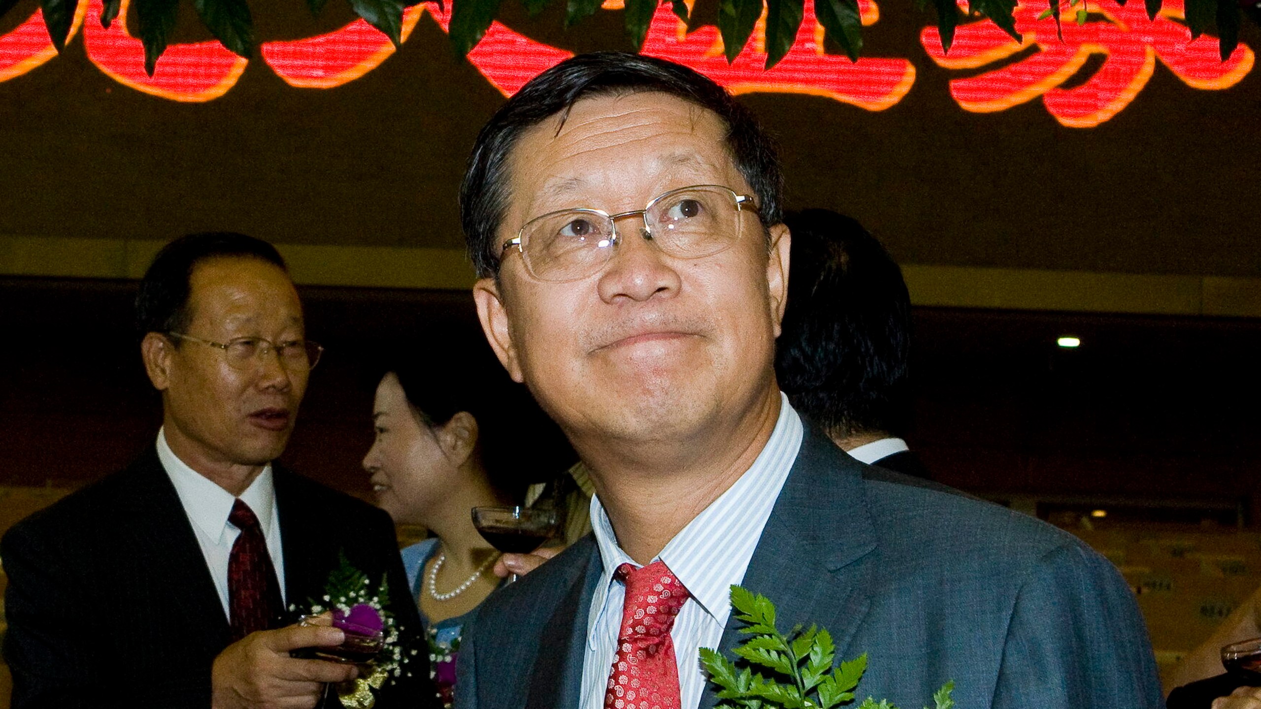 FILE - Tang Shuangning, right, then chairman of China Everbright Group and Everbright Securities Co., is pictured after toasting the IPO for Everbright Securities at Shanghai Stock Exchange in Shanghai, China on Aug. 18, 2009.(Chinatopix via AP, File)