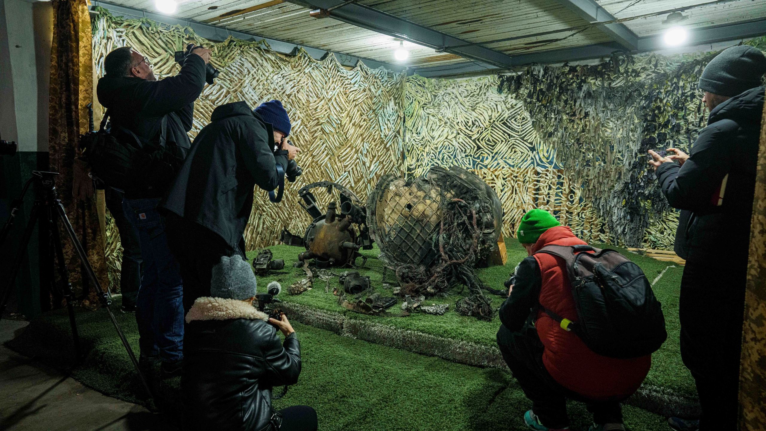 FILE - Journalists at a center for forensic analysis in undisclosed location in Ukraine on Nov. 24, 2024, film fragments of what authorities in Kyiv described as a Russian hypersonic missile that struck a factory in Dnipro, Ukraine, on Nov. 21. (AP Photo/Evgeniy Maloletka, File)