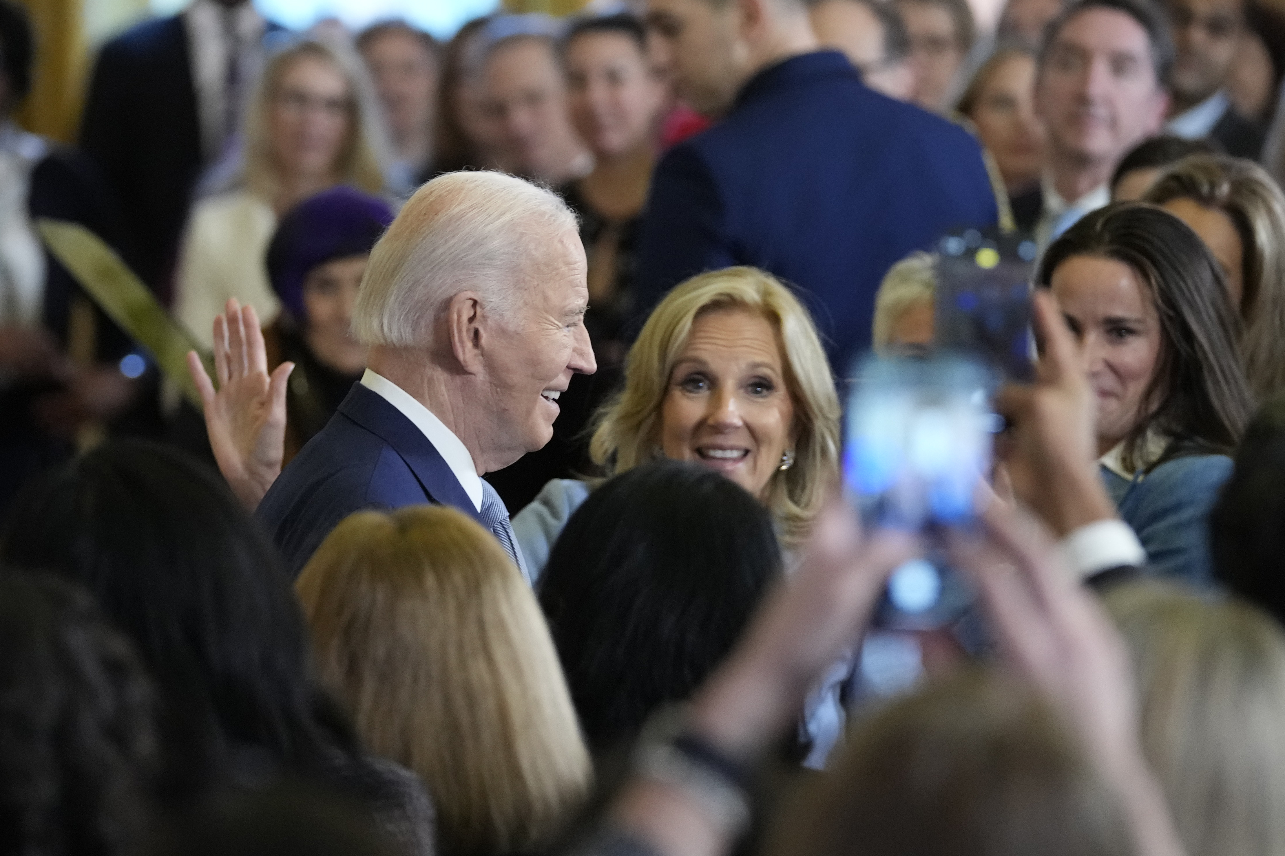 President Joe Biden, left, with first lady Jill Biden in the audience, center, and daughter Ashley Biden, right, walks out of the East Room of the White House after speaking at the White House Conference on Women's Health Research in Washington, Wednesday, Dec. 11, 2024. (AP Photo/Susan Walsh)