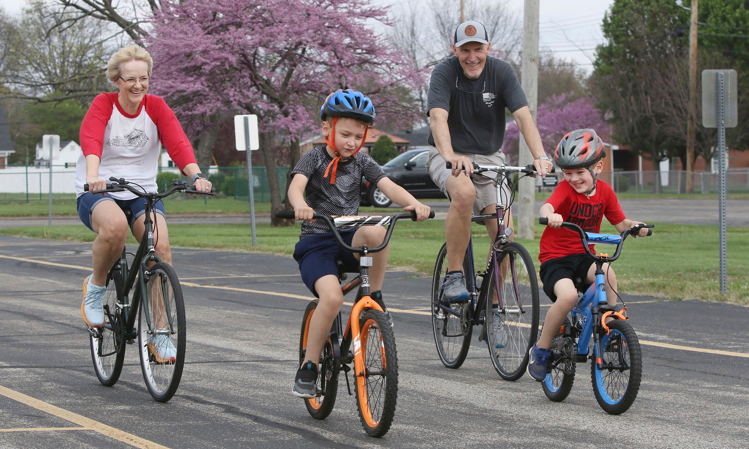 FILE - Gabriel Swift, 7, second left, wins a bike race against his brother, Isaiah Swift, 5, and his grandparents, Kim and Steve Swift, as they ride their bikes around the loop in the empty parking lot on Monday at One Faith Fellowship in the 1300 block of Tamarack in Owensboro, Ky., on April 1, 2024. (Alan Warren/The Messenger-Inquirer via AP)/The Messenger-Inquirer via AP, File)