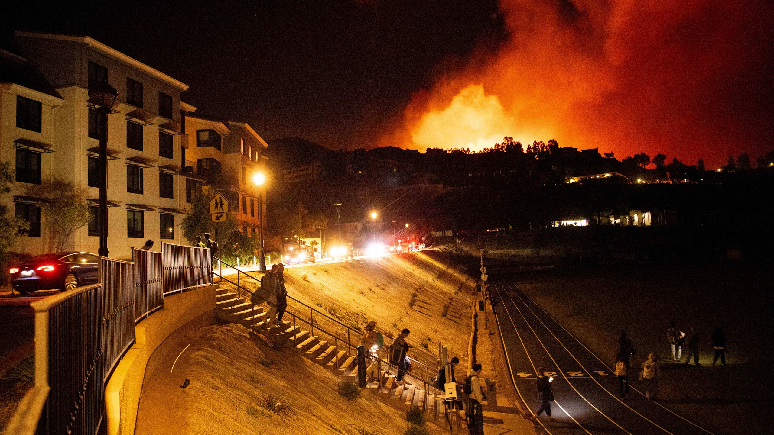 Students evacuate from Pepperdine University as the Franklin Fire burns in Malibu, Calif., on Tuesday, Dec. 10, 2024. (AP Photo/Ethan Swope)