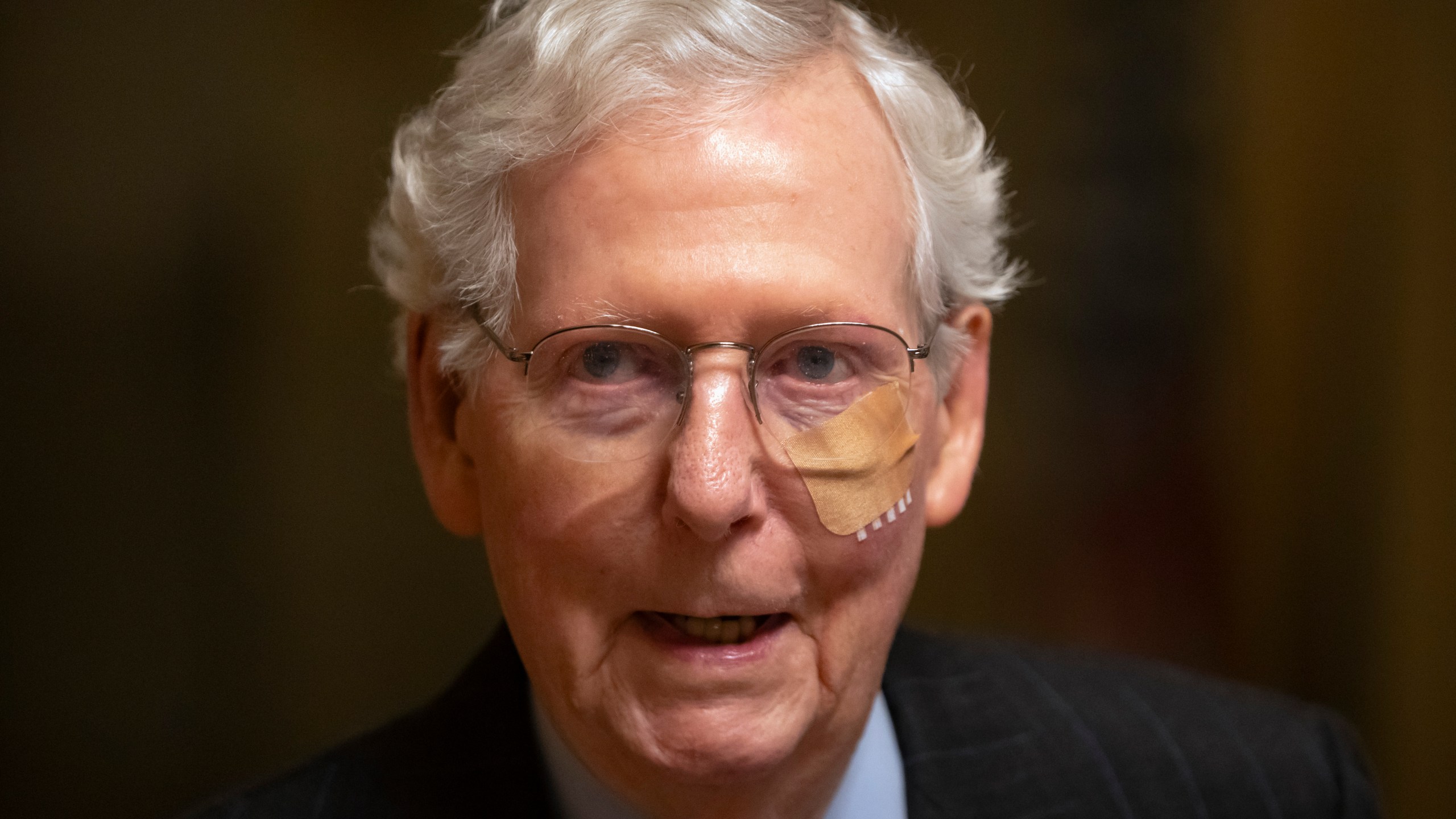 Senate Minority Leader Mitch McConnell of Ky. wears a bandage on his face as he walks to cast a vote on the Senate floor after falling during a luncheon on Capitol Hill, Tuesday, Dec. 10, 2024, in Washington. (AP Photo/Mark Schiefelbein)