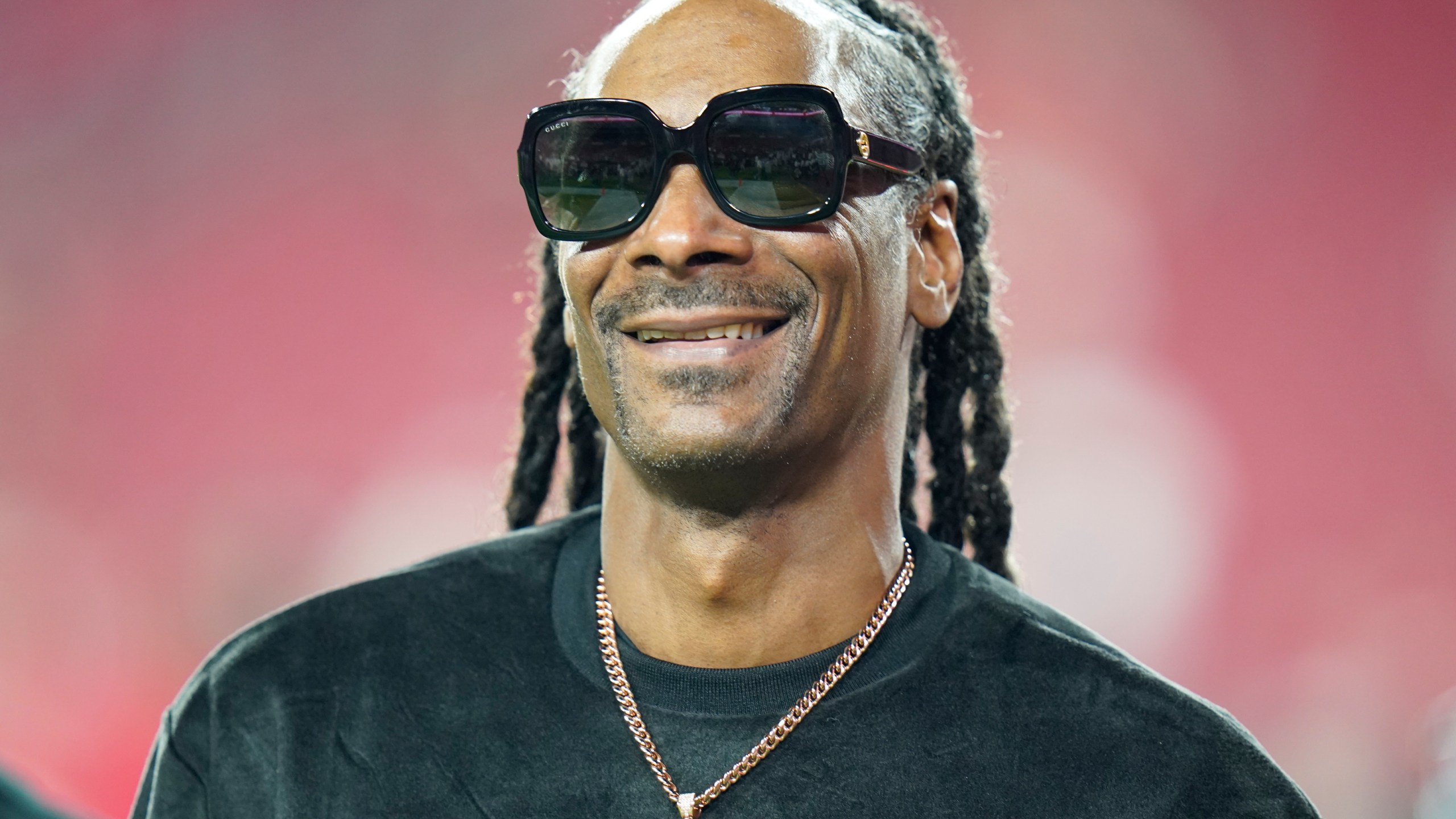 FILE - Entertainer Snoop Dogg walks on the field before an NFL football game between the Tampa Bay Buccaneers and the New Orleans Saints on Dec. 19, 2021, in Tampa, Fla. (AP Photo/Chris O'Meara, File)