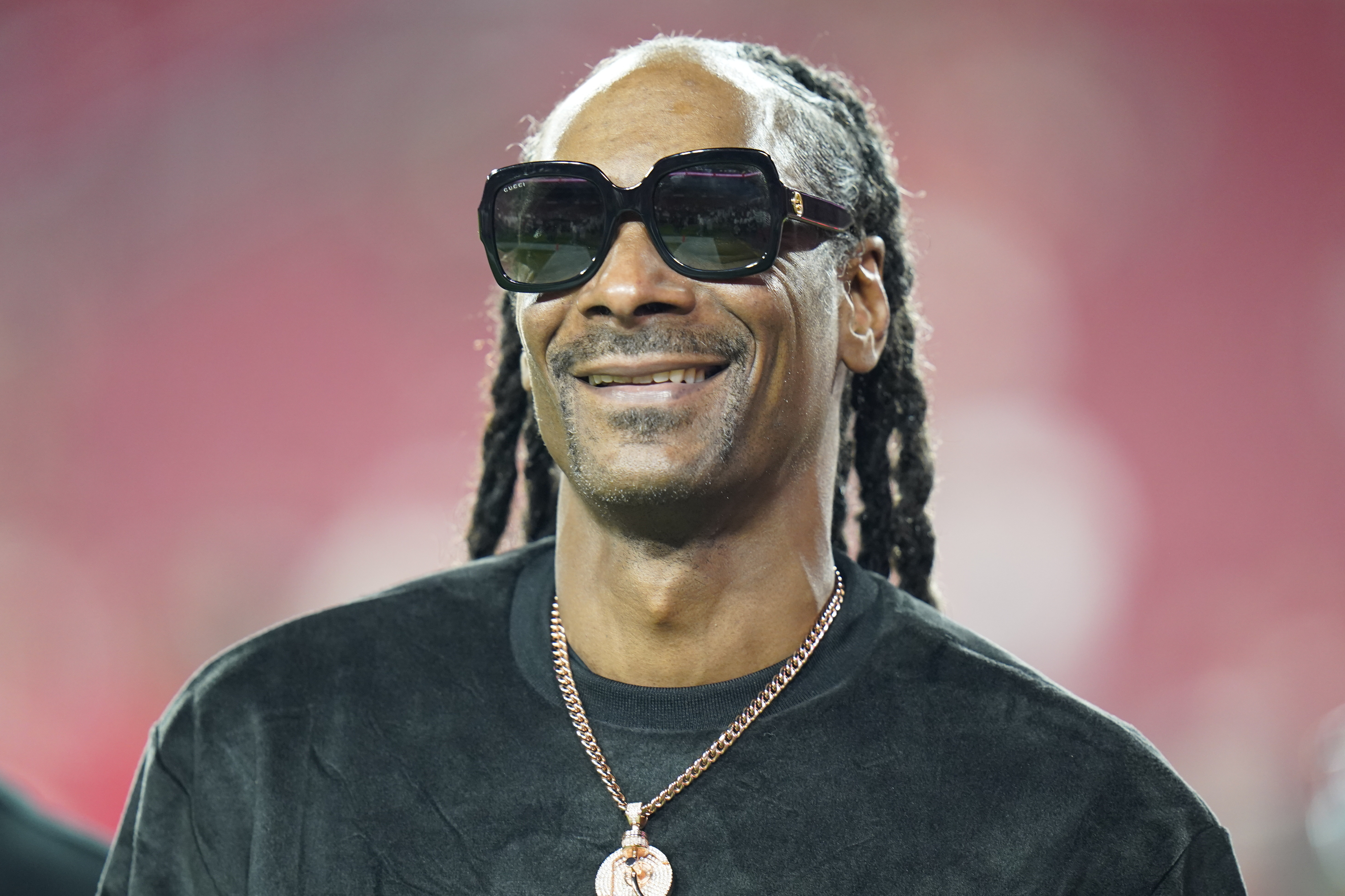 FILE - Entertainer Snoop Dogg walks on the field before an NFL football game between the Tampa Bay Buccaneers and the New Orleans Saints on Dec. 19, 2021, in Tampa, Fla. (AP Photo/Chris O'Meara, File)