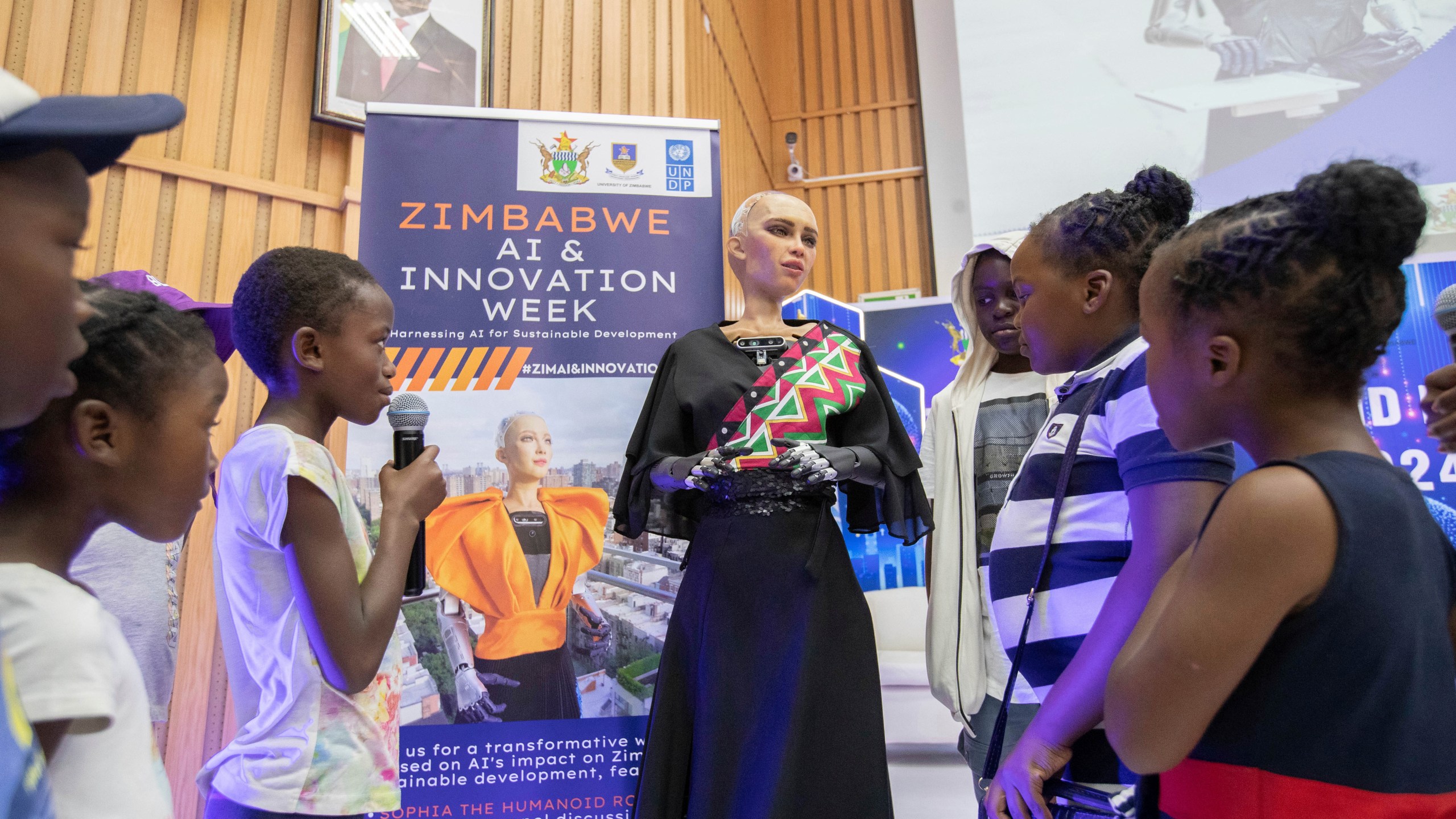 Sophia, the humanoid robot, responds to questions from children at the University of Zimbabwe, Harare, Friday, 13 Dec. 2024. (AP Photo/Aaron Ufumeli)