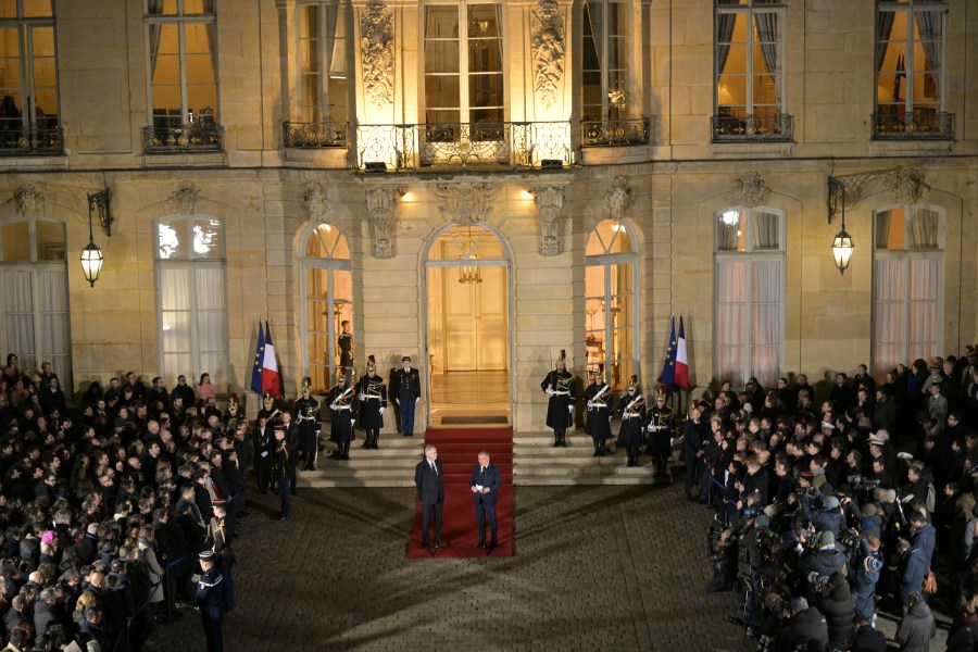 France's newly appointed Prime Minister Francois Bayrou, right, and outgoing Prime minister Michel Barnier speak after the handover ceremony at the Hotel Matignon , the Prime Minister residence, in Paris, Friday Dec. 13, 2024.( Bertrand Guay/ Pool via AP)