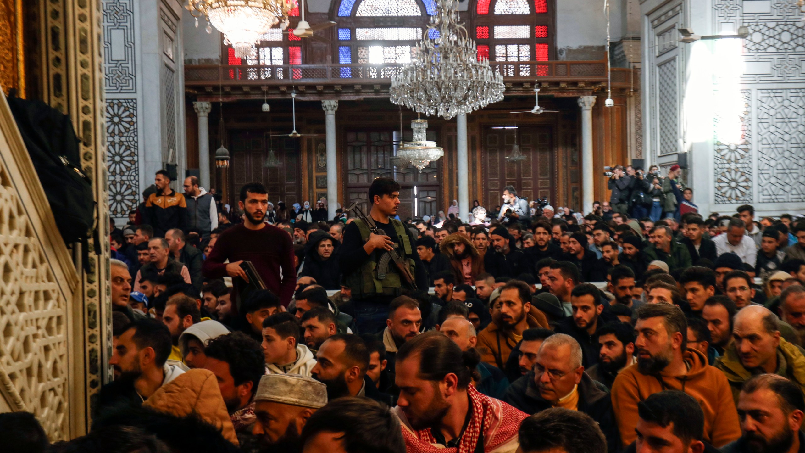 Syrians perform Friday prayers inside the 7th century Umayyad Mosque in Damascus, Syria, Friday, Dec. 13, 2024. (AP Photo/Omar Sanadiki)