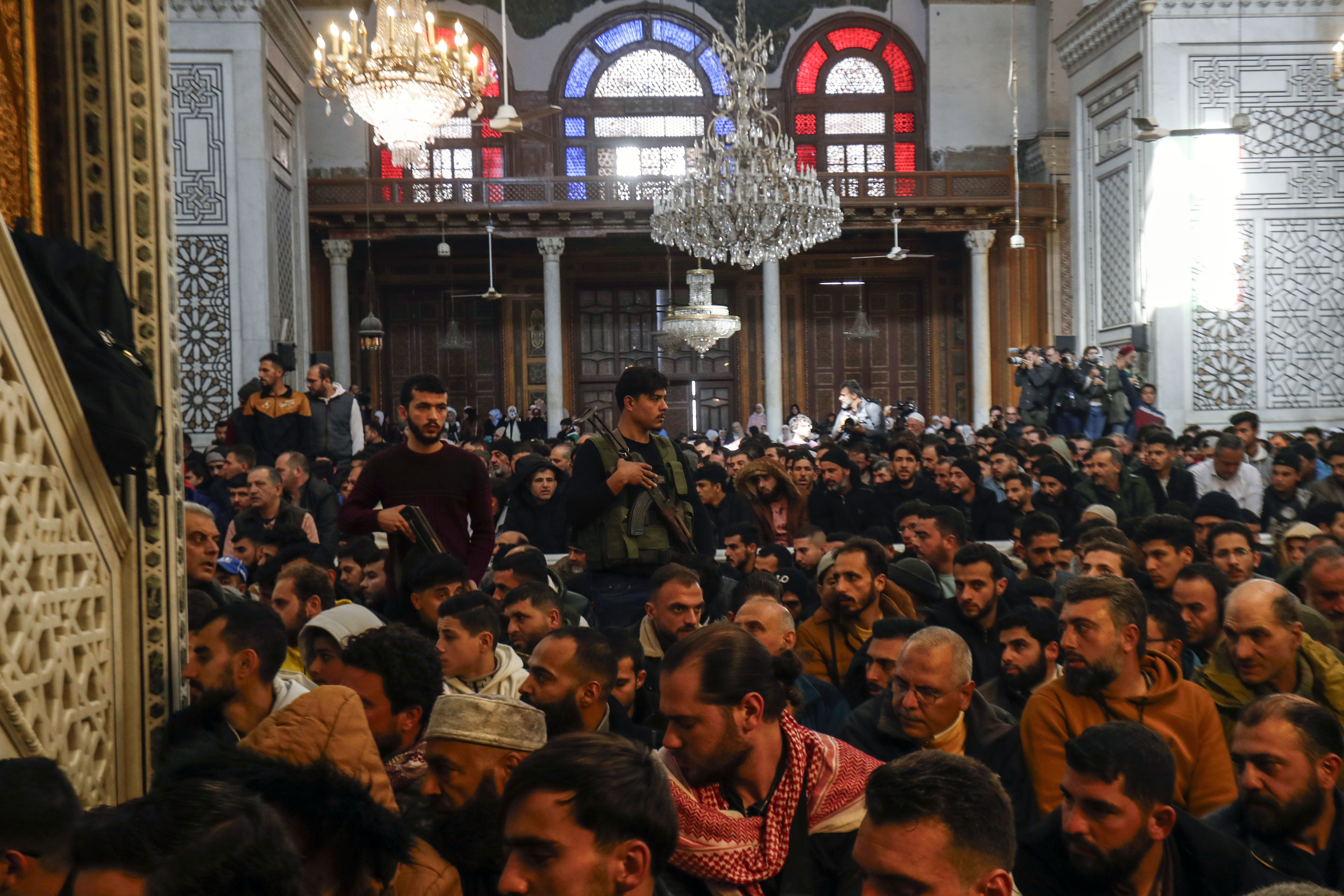 Syrians perform Friday prayers inside the 7th century Umayyad Mosque in Damascus, Syria, Friday, Dec. 13, 2024. (AP Photo/Omar Sanadiki)