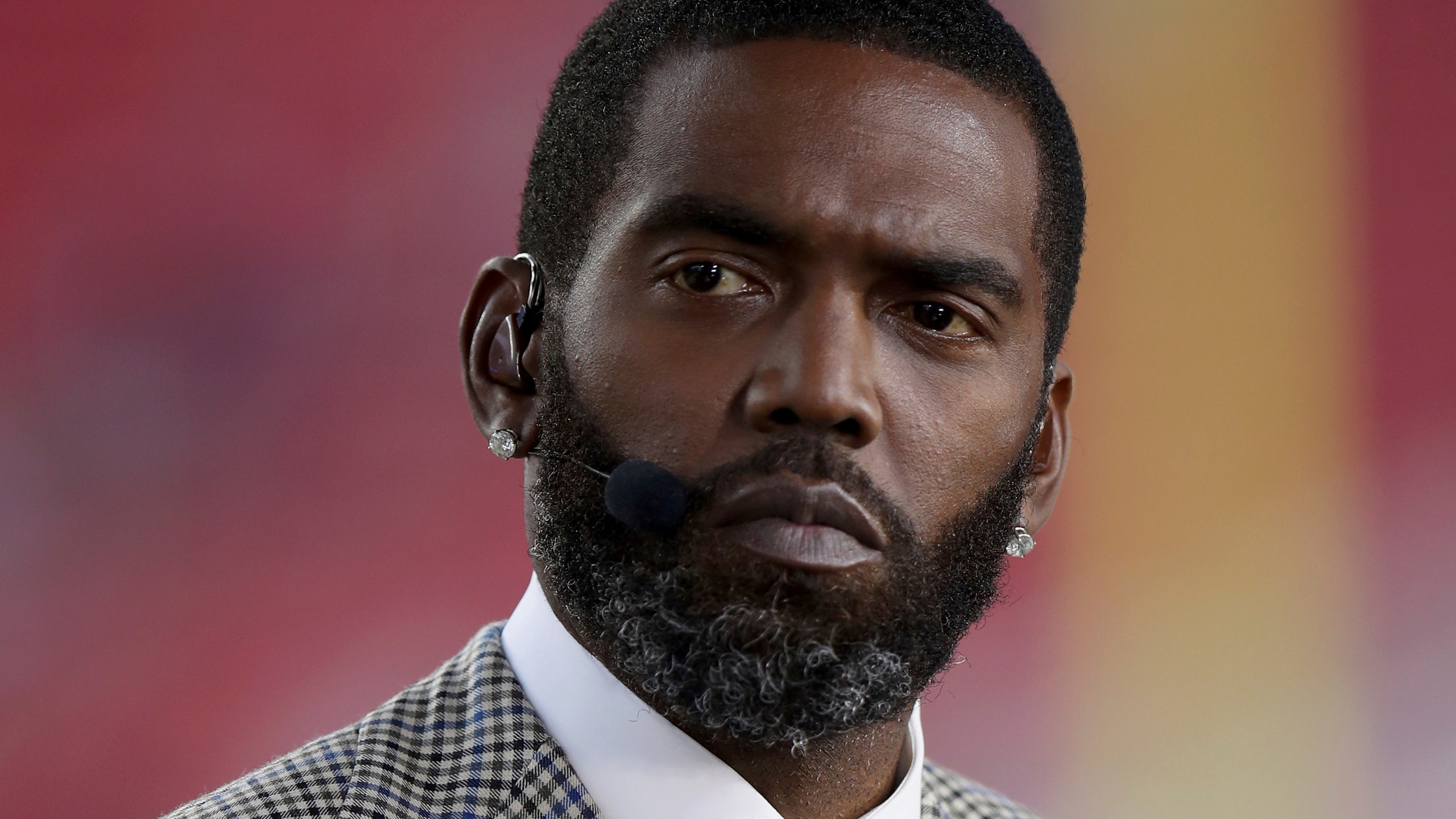 FILE - Broadcaster Randy Moss sits on the sideline before an NFL football game between the San Francisco 49ers and the Los Angeles Rams, Monday, Nov. 15, 2021, in Santa Clara, Calif. (AP Photo/Scot Tucker, File)