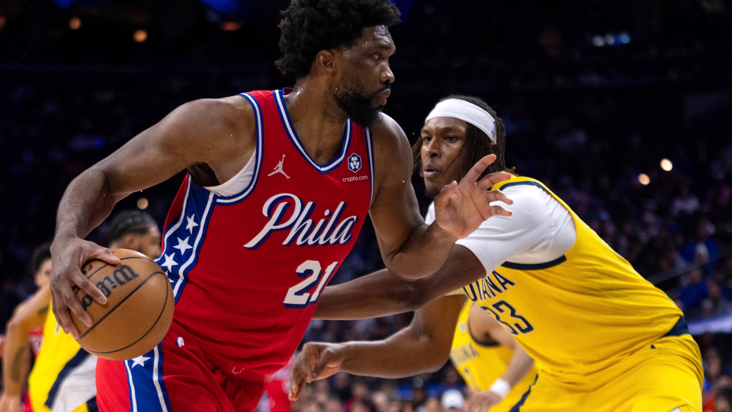 Philadelphia 76ers' Joel Embiid, left, drives to the basket against Indiana Pacers' Myles Turner, right, during the first half of an NBA basketball game, Friday, Dec. 13, 2024, in Philadelphia. (AP Photo/Chris Szagola)