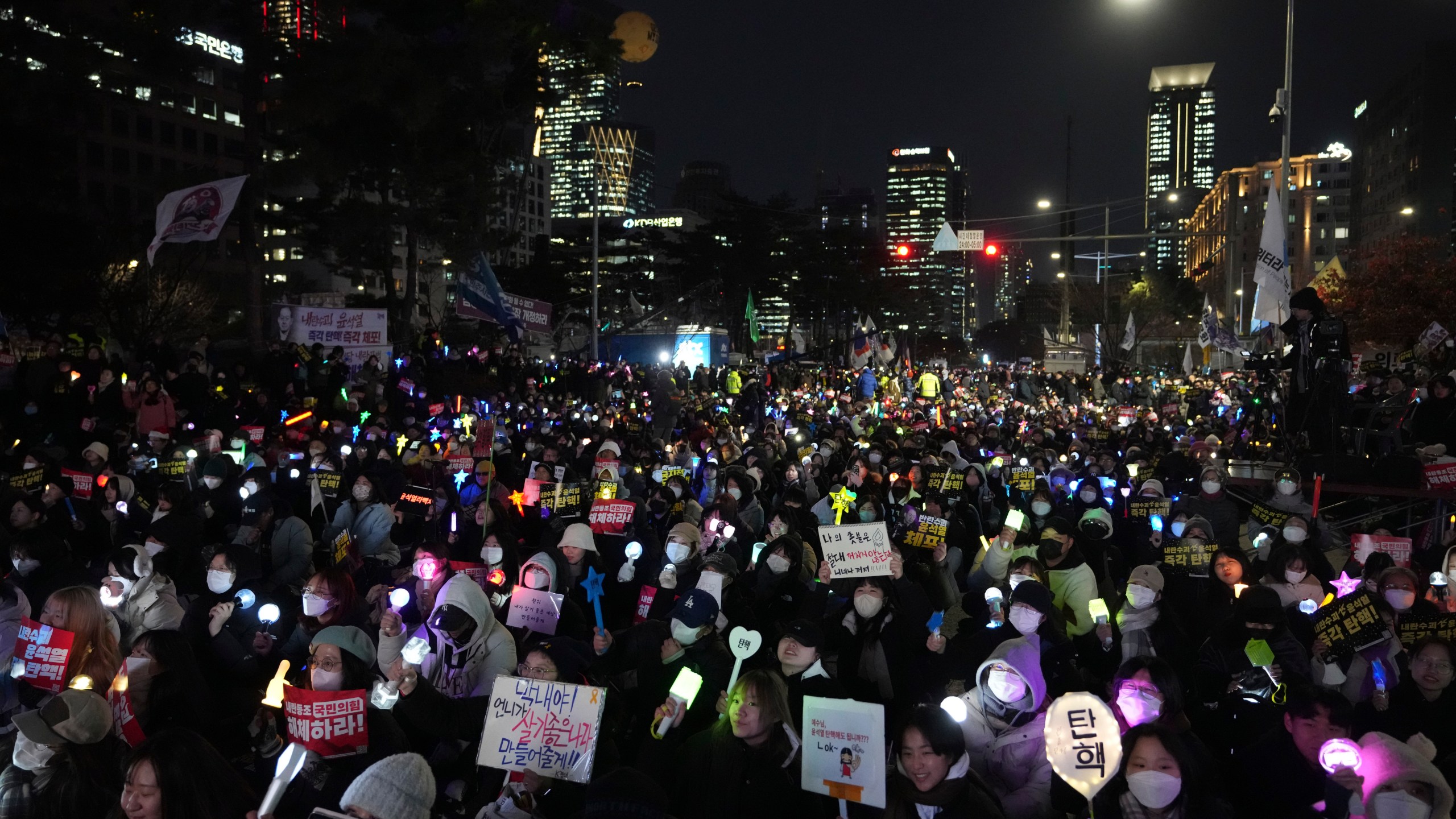 Protesters stage a rally to demand South Korean President Yoon Suk Yeol's impeachment outside the National Assembly in Seoul, South Korea, Thursday, Dec. 12, 2024. The banners read "Impeachment ." (AP Photo/Lee Jin-man)