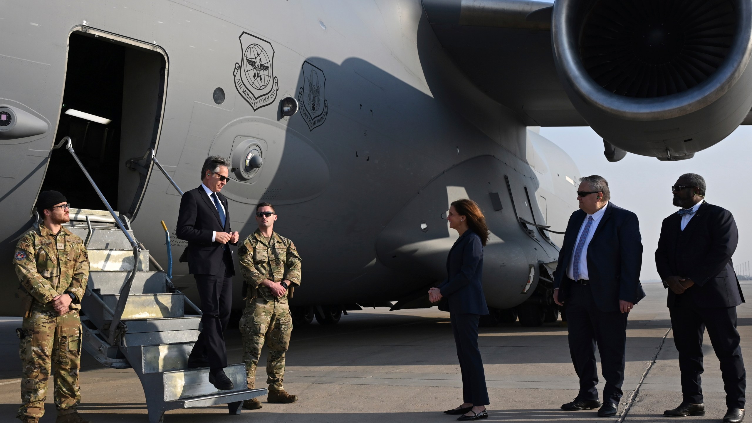 US Secretary of State Antony Blinken, second left, is welcomed by US officials upon landing in Baghdad, Iraq, Friday, Dec. 13, 2024. (Andrew Caballero-Reynolds/Pool Photo via AP)