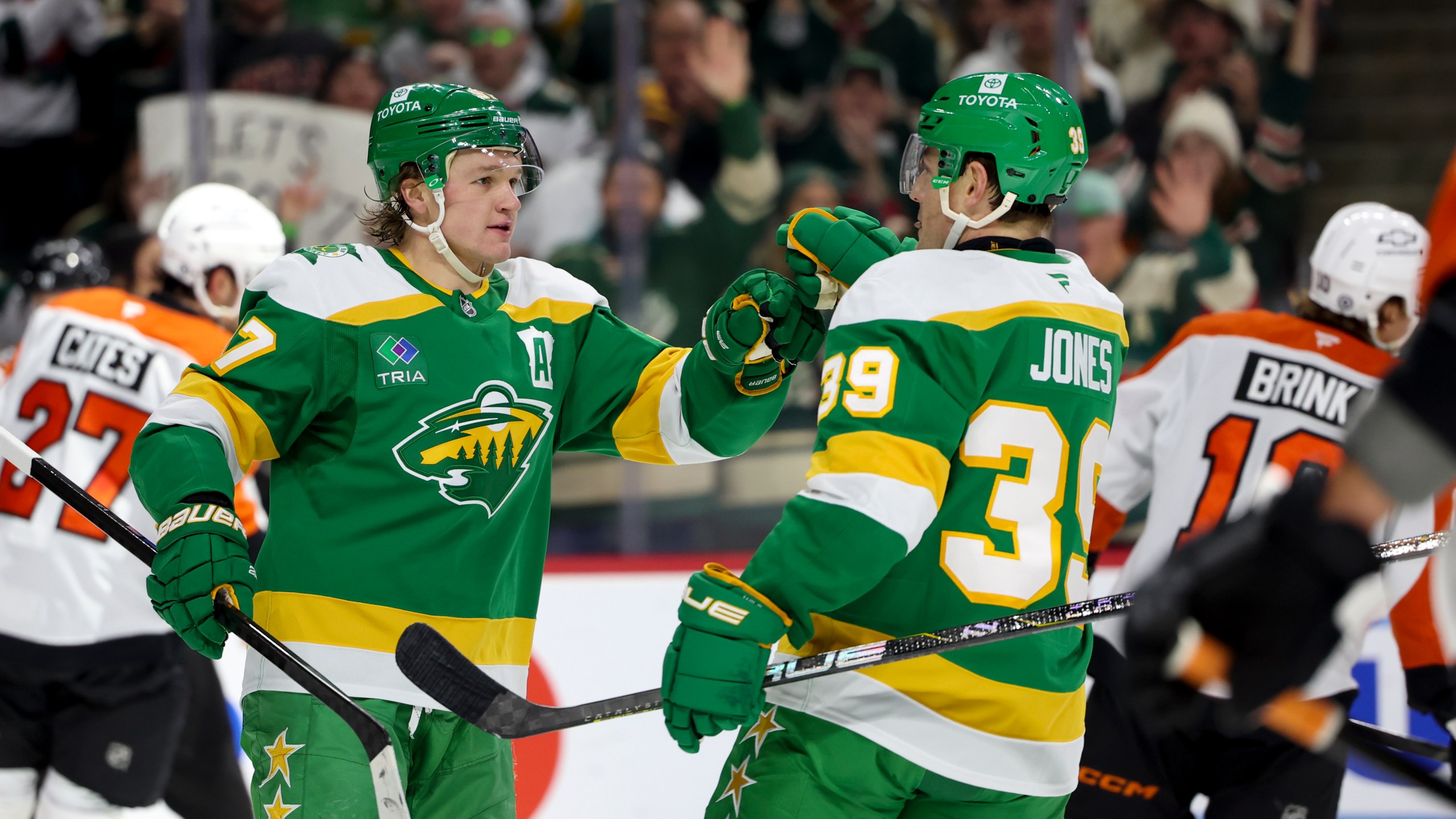 Minnesota Wild left wing Kirill Kaprizov, left, celebrates his goal with center Ben Jones (39) during the first period of an NHL hockey game against the Philadelphia Flyers, Saturday, Dec. 14, 2024, in St. Paul, Minn. (AP Photo/Ellen Schmidt)