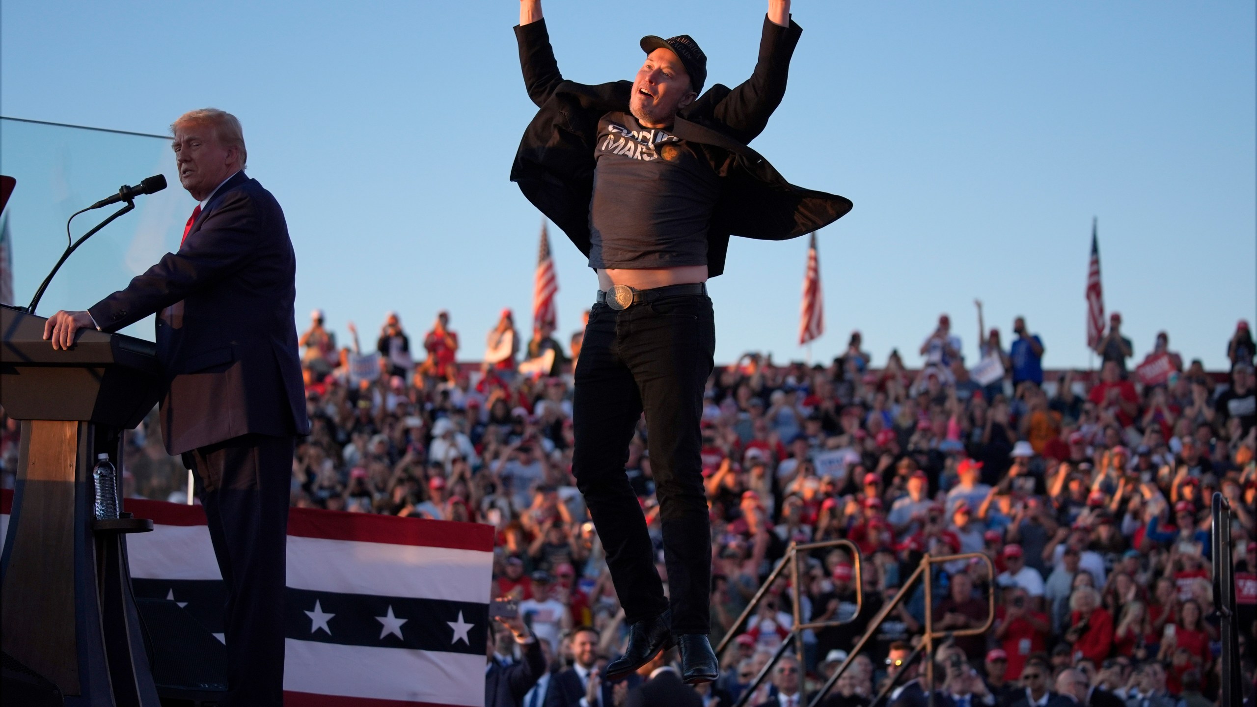 FILE - Elon Musk jumps on the stage as Republican presidential nominee former President Donald Trump speaks at a campaign rally at the Butler Farm Show, Oct. 5, 2024, in Butler, Pa. (AP Photo/Evan Vucci, File)