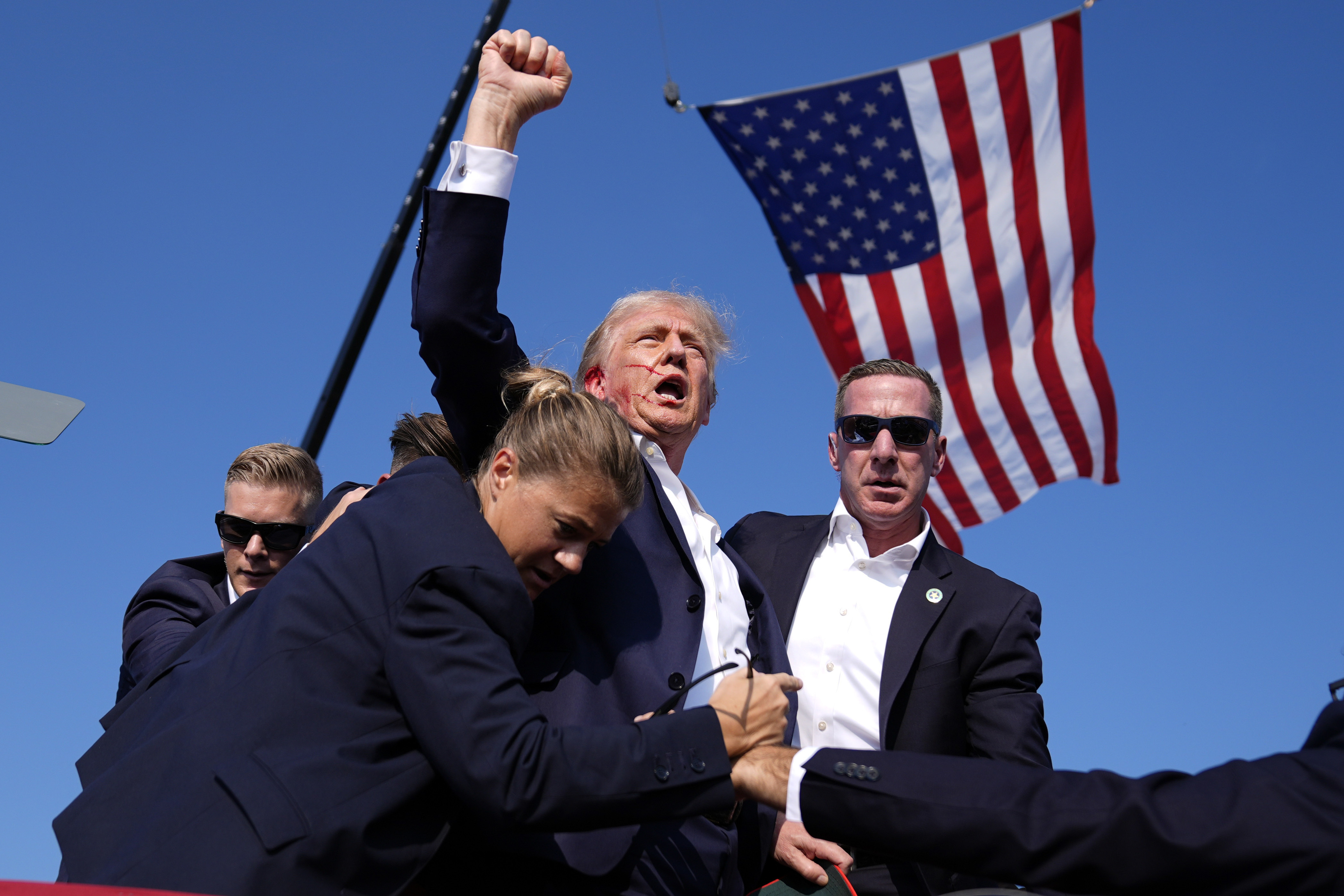 FILE - Republican presidential candidate former President Donald Trump is surrounded by U.S. Secret Service agents after an assassination attempt at a campaign rally in Butler, Pa., July 13, 2024. (AP Photo/Evan Vucci, File)